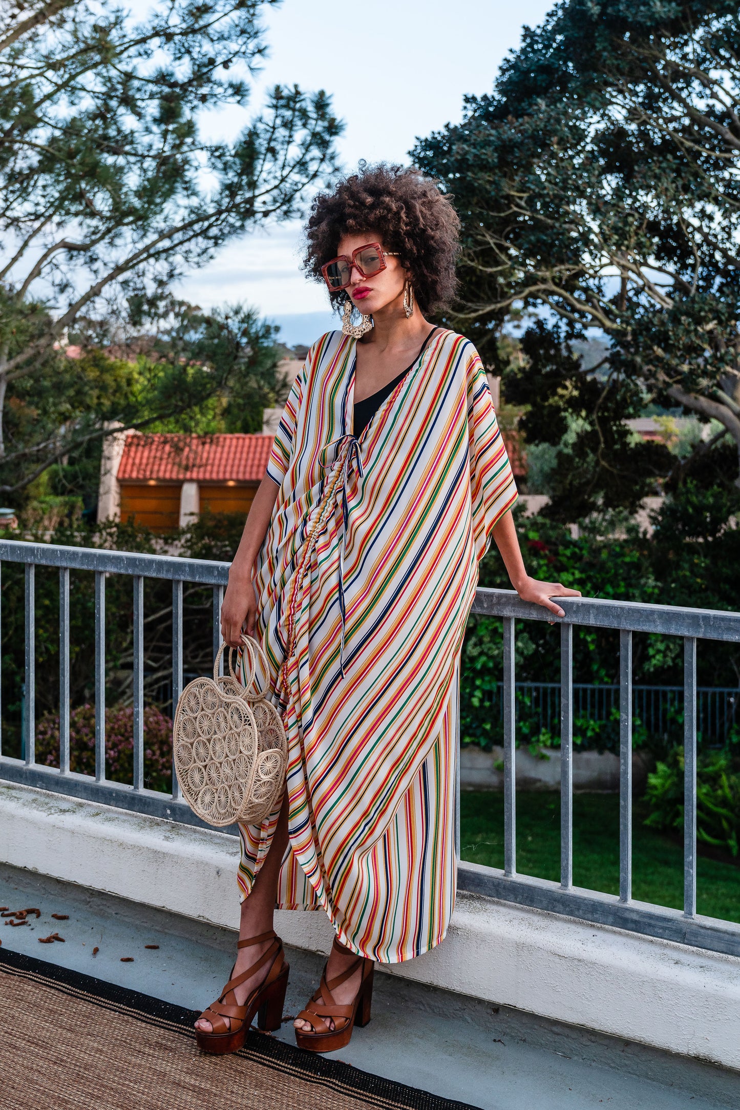 Multicolor vertical stripes on ivory chiffon caftan. This piece features a deep v-neck, batwing sleeve, a center drawstring for ruche styling, and ankle length hem. Retro bohemian aesthetic.