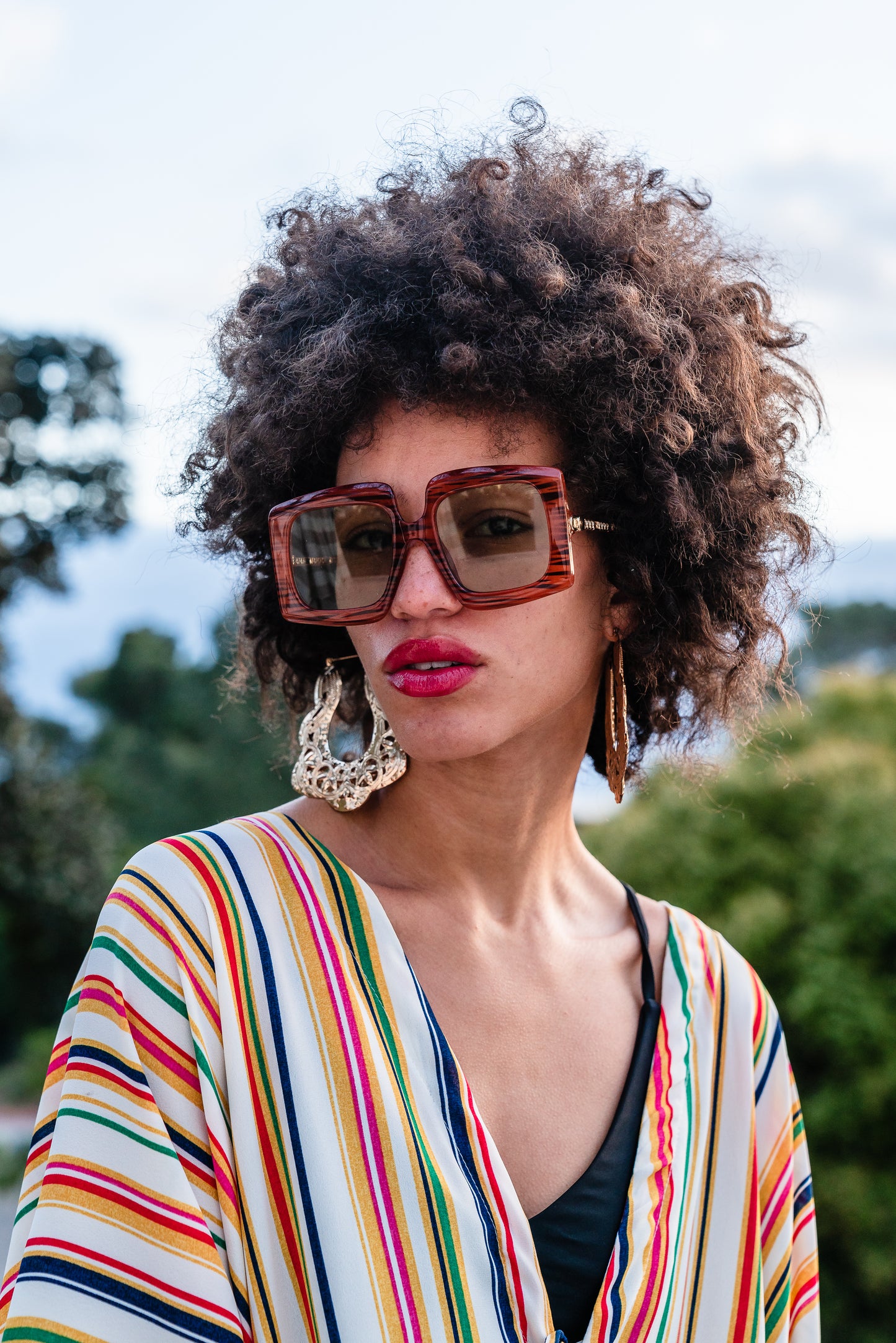 Multicolor vertical stripes on ivory chiffon caftan. This piece features a deep v-neck, batwing sleeve, a center drawstring for ruche styling, and ankle length hem. Retro bohemian aesthetic.