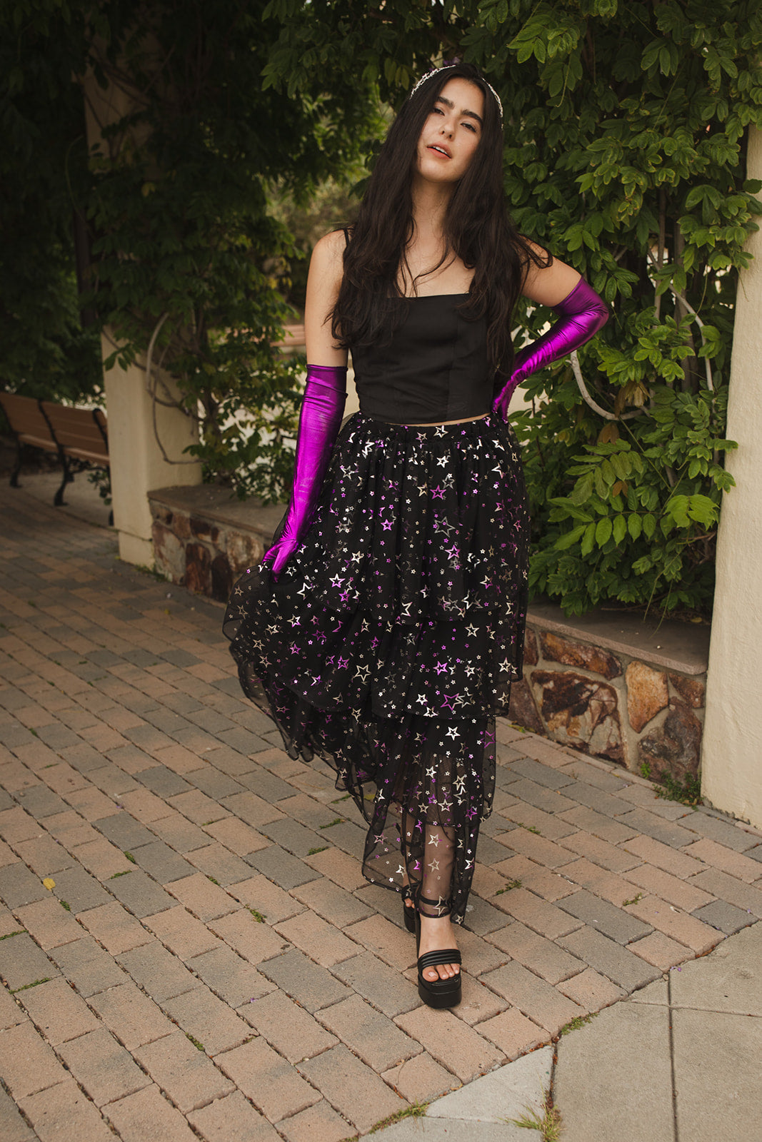 A tiered maxi skirt. Crafted with four tiers of layered black and metallic silver/purple stars and an elastic waist for all-day comfort. High waist with ankle hem.