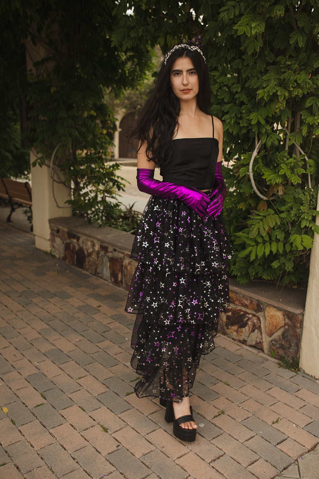 A tiered maxi skirt. Crafted with four tiers of layered black and metallic silver/purple stars and an elastic waist for all-day comfort. High waist with ankle hem.
