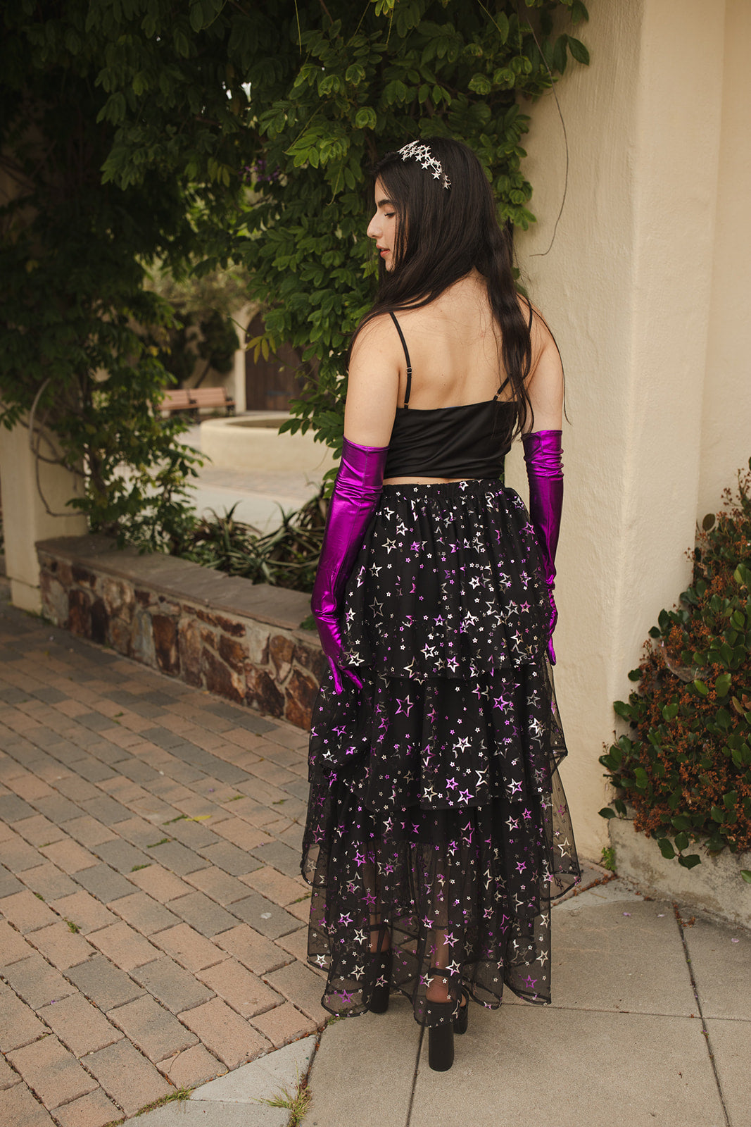 A tiered maxi skirt. Crafted with four tiers of layered black and metallic silver/purple stars and an elastic waist for all-day comfort. High waist with ankle hem.