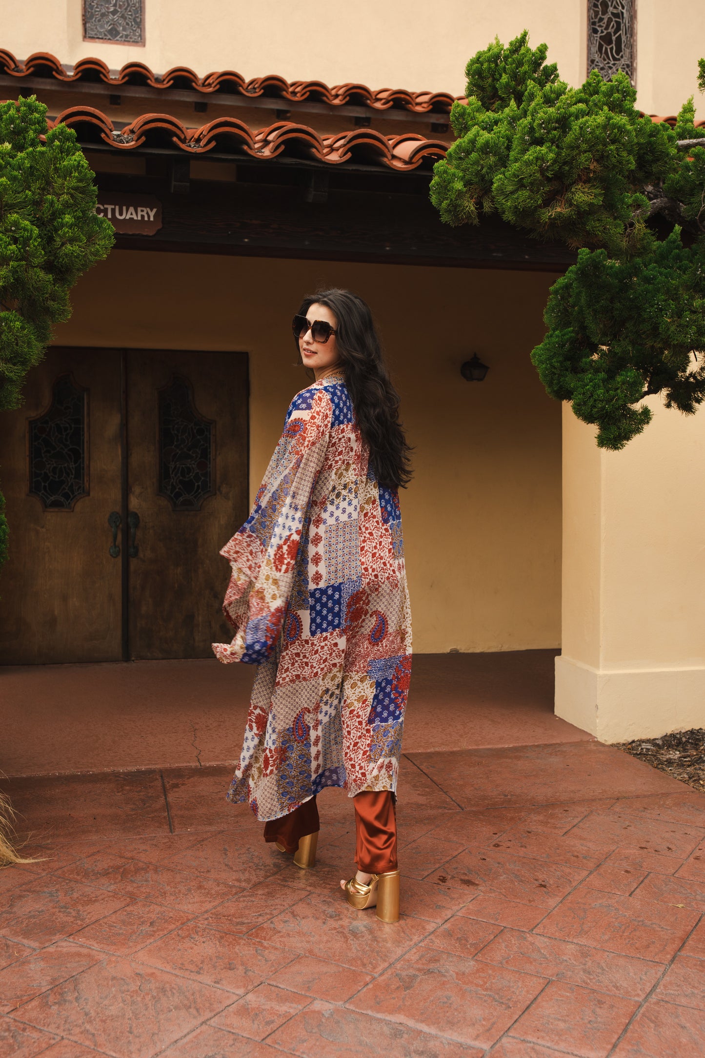 Long sleeve kimono with ankle length hem is made from a soft semi-sheer rayon chiffon. Featuring a paisley boho pattern in a mixture of red, blue, tan, and yellow. It also features pockets and a matching waist tie-you can style this piece in at least 10 ways.