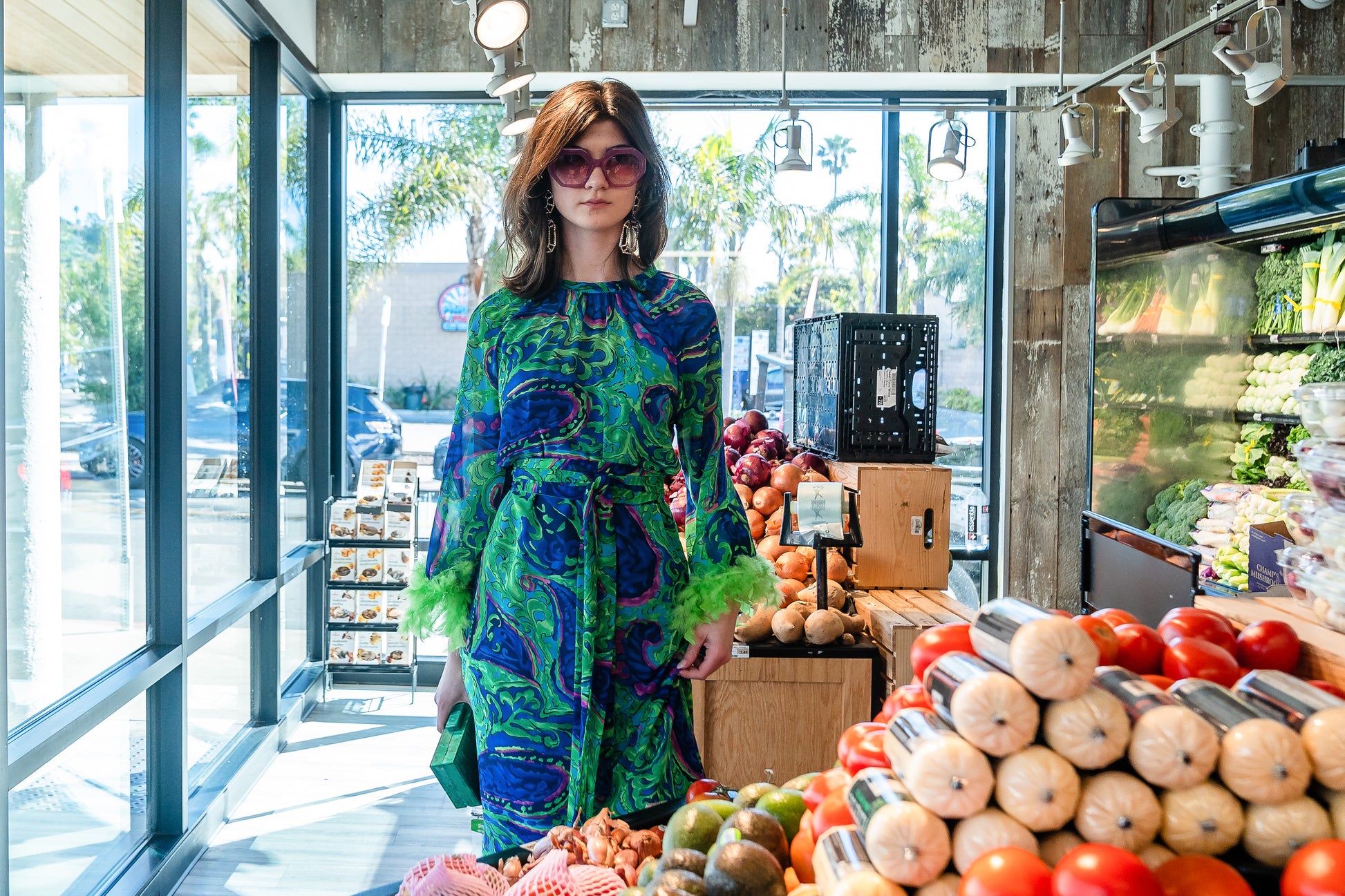 Funky fresh retro midi dress with royal blue and lime green abstract filigree swirl print with hints of aqua and fuchsia. The dress features a crew neck, keyhole detail at upper back, 3/4 bell sleeves with neon green feathers at cuff, a knee-length hem, and optional wrap tie for a cinched waist.