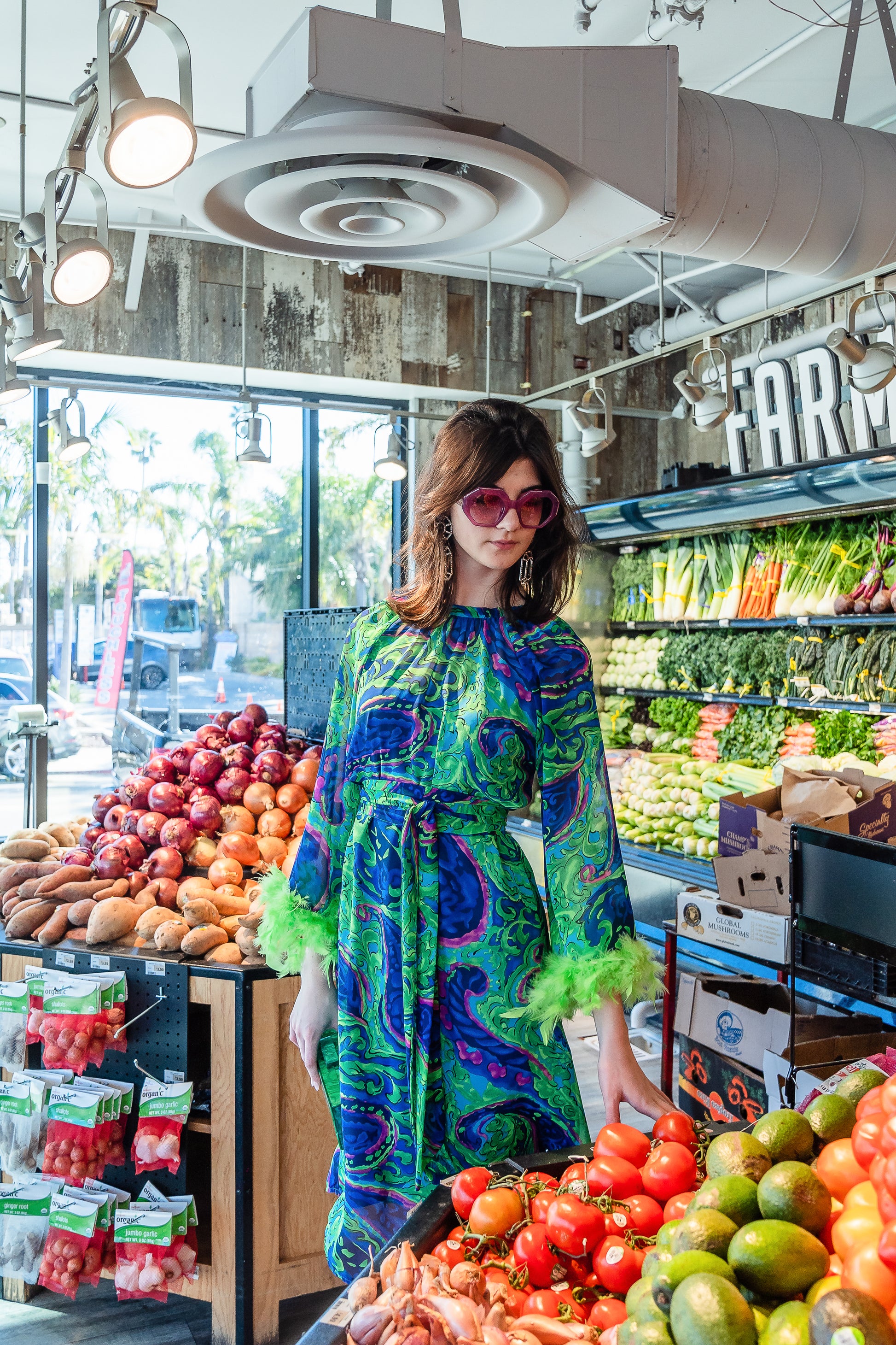 Funky fresh retro midi dress with royal blue and lime green abstract filigree swirl print with hints of aqua and fuchsia. The dress features a crew neck, keyhole detail at upper back, 3/4 bell sleeves with neon green feathers at cuff, a knee-length hem, and optional wrap tie for a cinched waist.