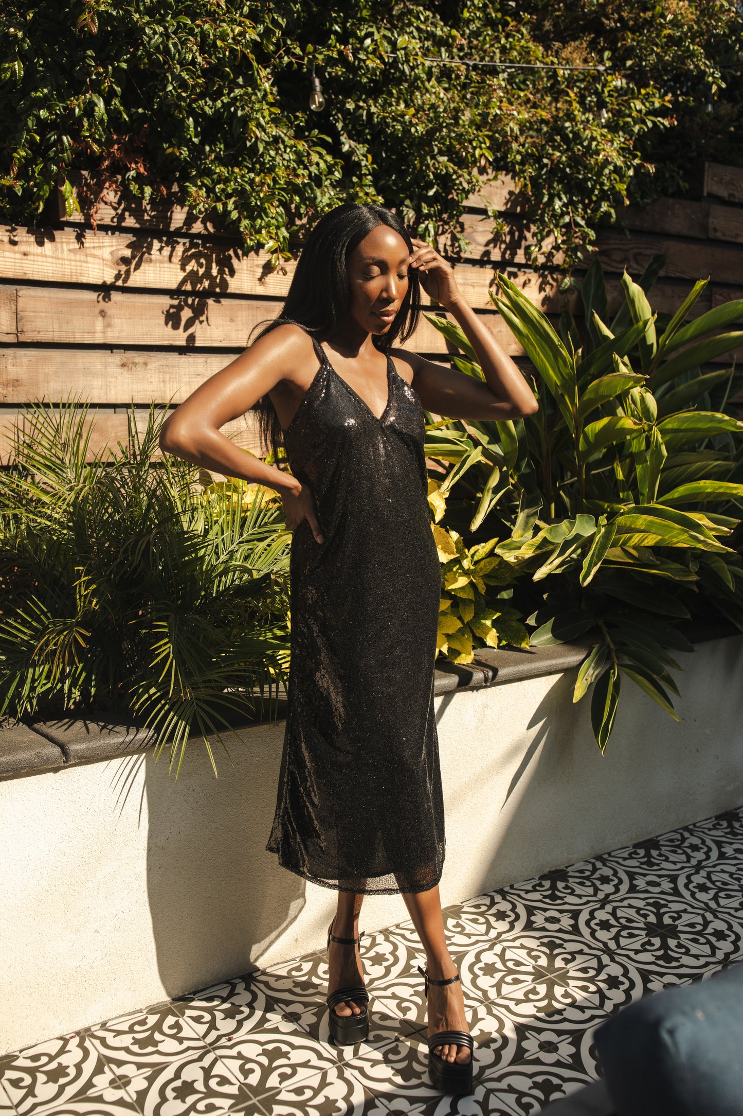 Black sequin layered slip dress featuring spaghetti strap and midi hemline.