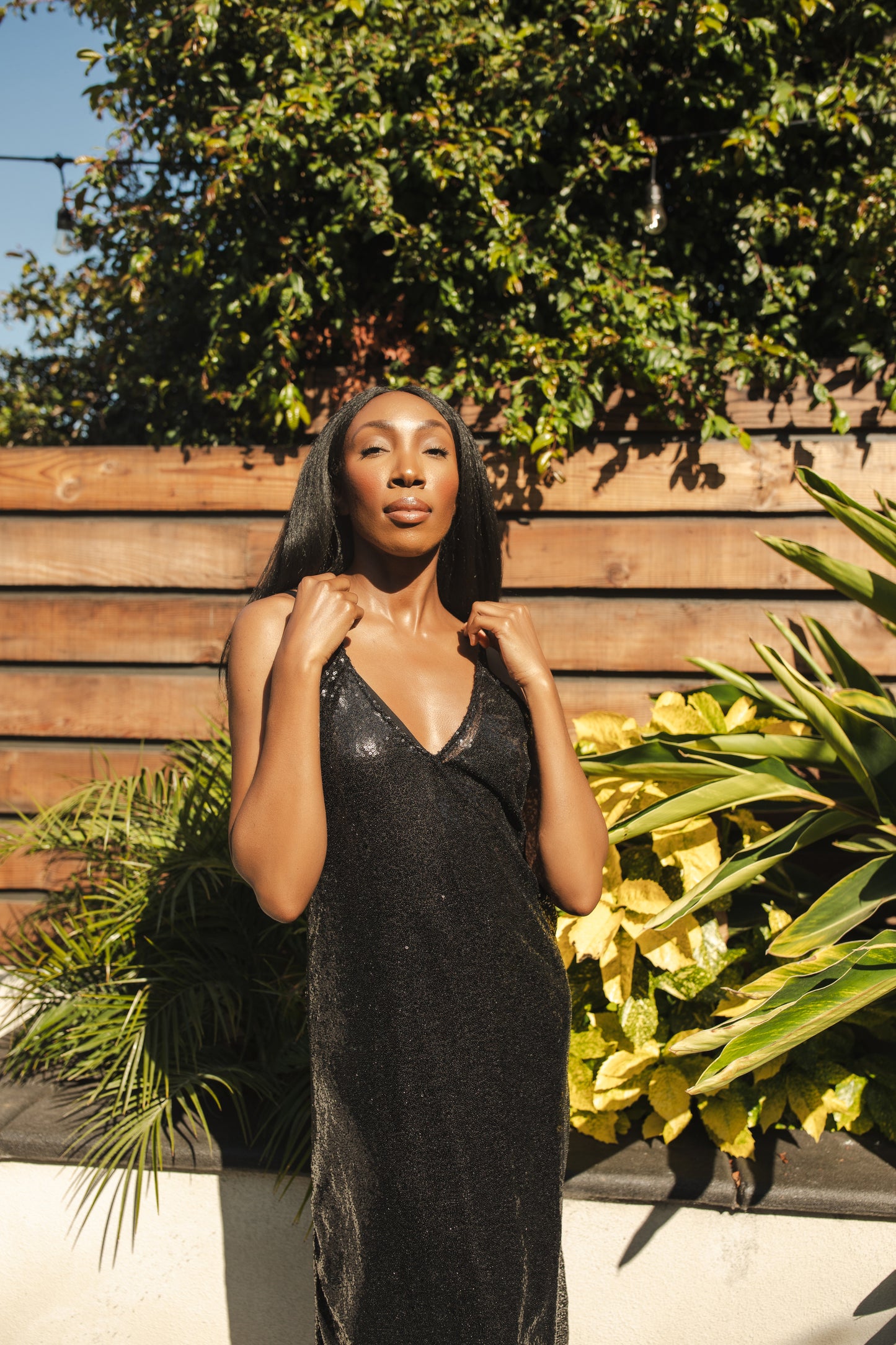 Black sequin layered slip dress featuring spaghetti strap and midi hemline.