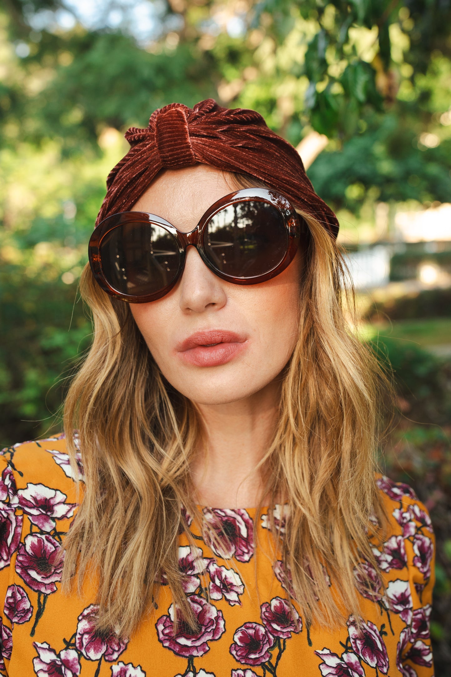 Dark rust, burnt sienna, ribbed stretch velvet fashion turban hat that wears similar to a beanie, with ruching of the fabric that meets front and center at an elegant knot. Vintage-inspired retro 1920s mixed with a modern fabric.