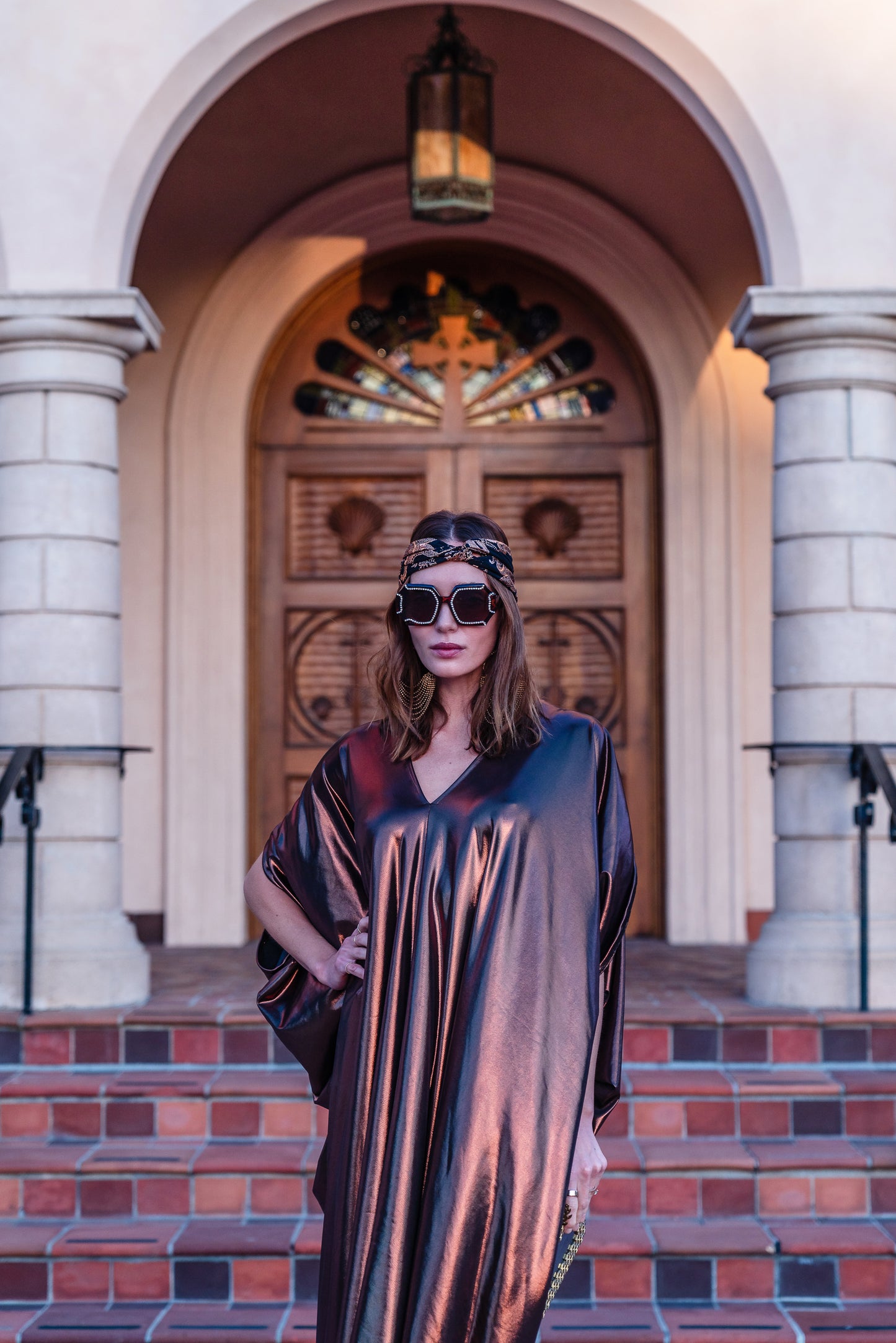 This copper caftan offers a sleek and shimmering look that exudes boldness and luxury made from a generous amount of metallic coated poly/spandex jersey.
