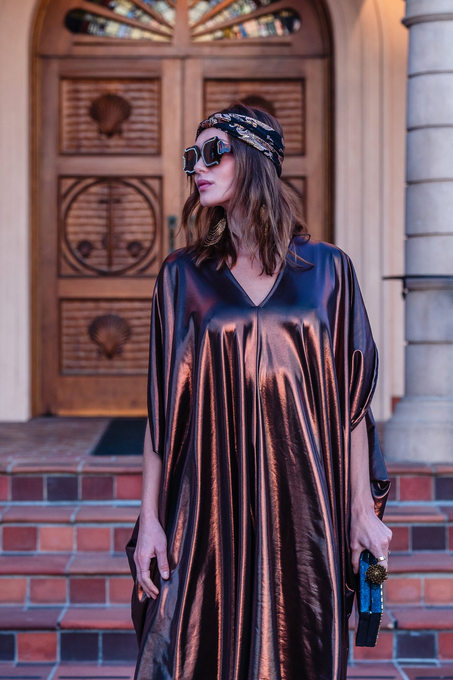 This copper caftan offers a sleek and shimmering look that exudes boldness and luxury made from a generous amount of metallic coated poly/spandex jersey.
