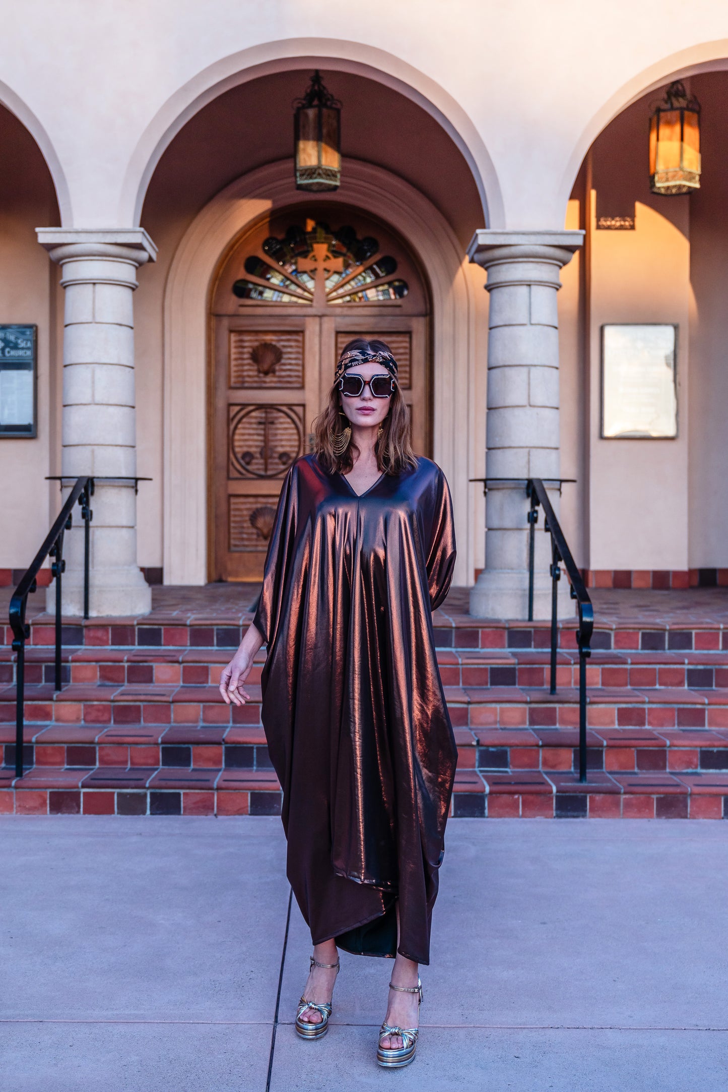 This copper caftan offers a sleek and shimmering look that exudes boldness and luxury made from a generous amount of metallic coated poly/spandex jersey.