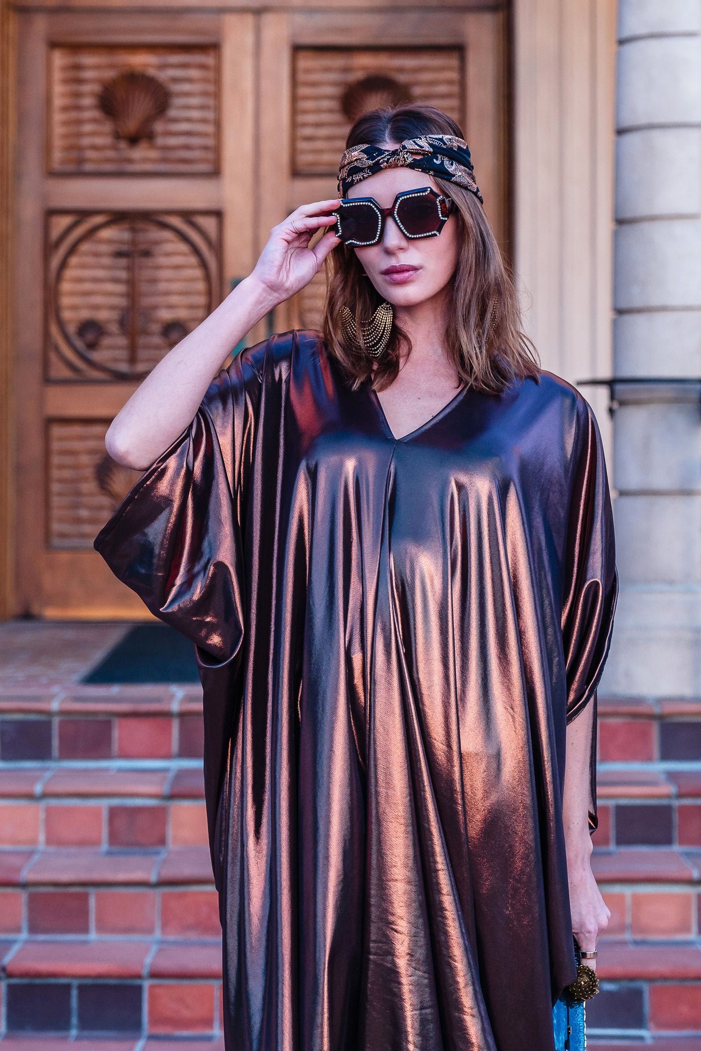 This copper caftan offers a sleek and shimmering look that exudes boldness and luxury made from a generous amount of metallic coated poly/spandex jersey.