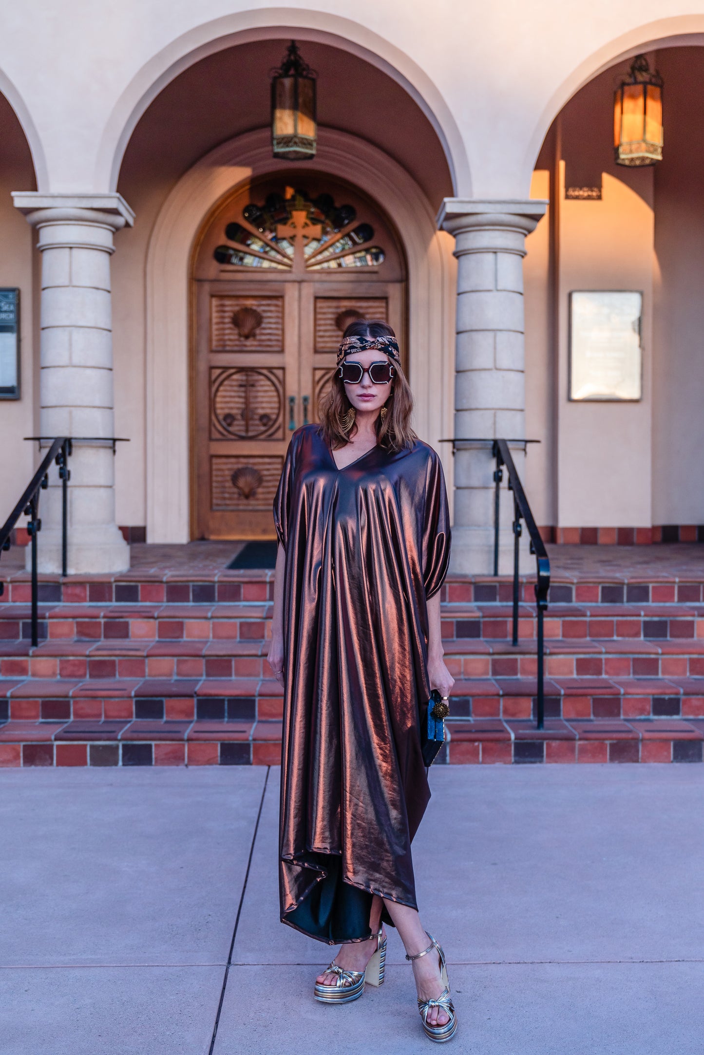 This copper caftan offers a sleek and shimmering look that exudes boldness and luxury made from a generous amount of metallic coated poly/spandex jersey.