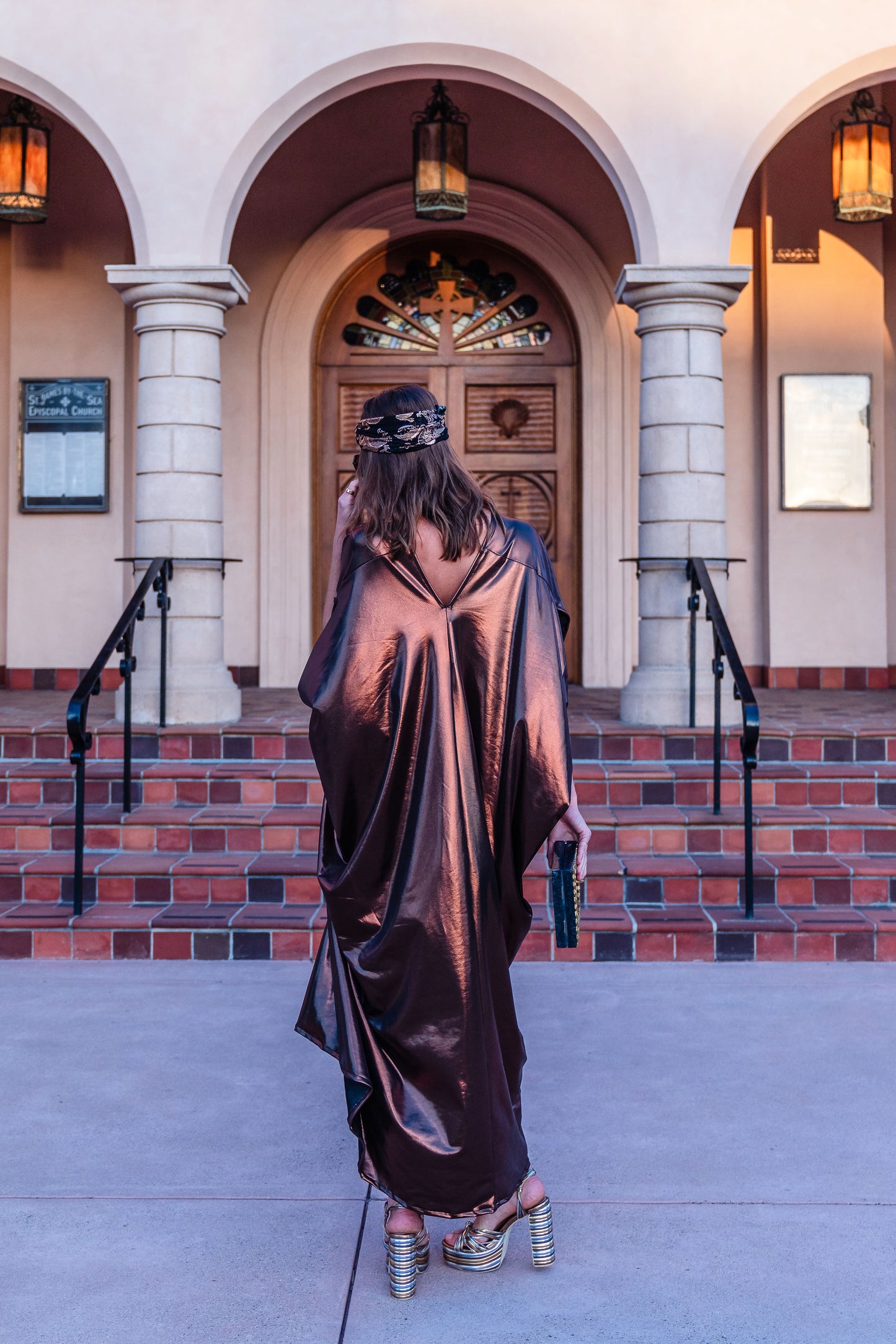 This copper caftan offers a sleek and shimmering look that exudes boldness and luxury made from a generous amount of metallic coated poly/spandex jersey.
