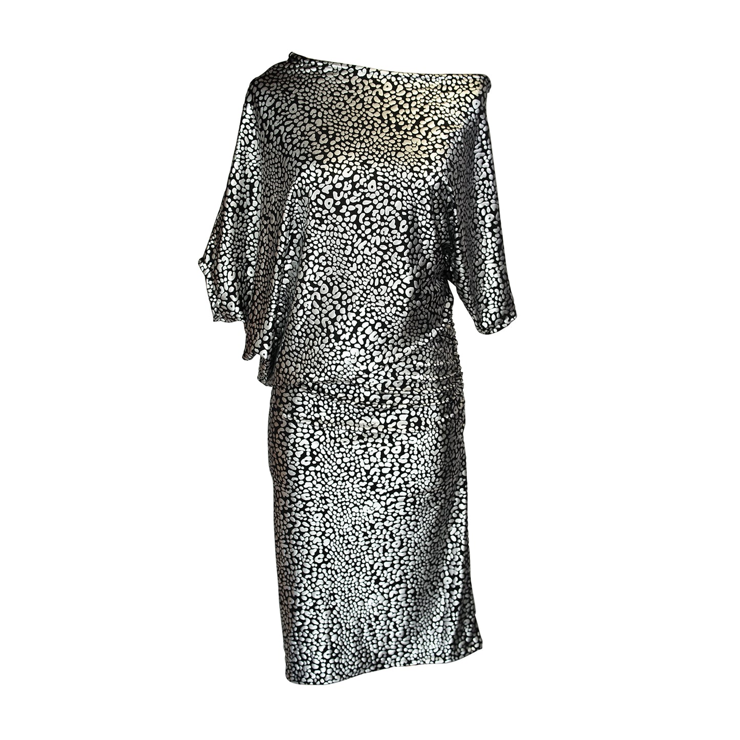 An angle dress made from a silver leopard foil-detailed stretchy jersey, featuring a fitted pencil skirt and light ruching at the hip. The angled sleeves can be arranged for a peek of shoulder and bra strap.