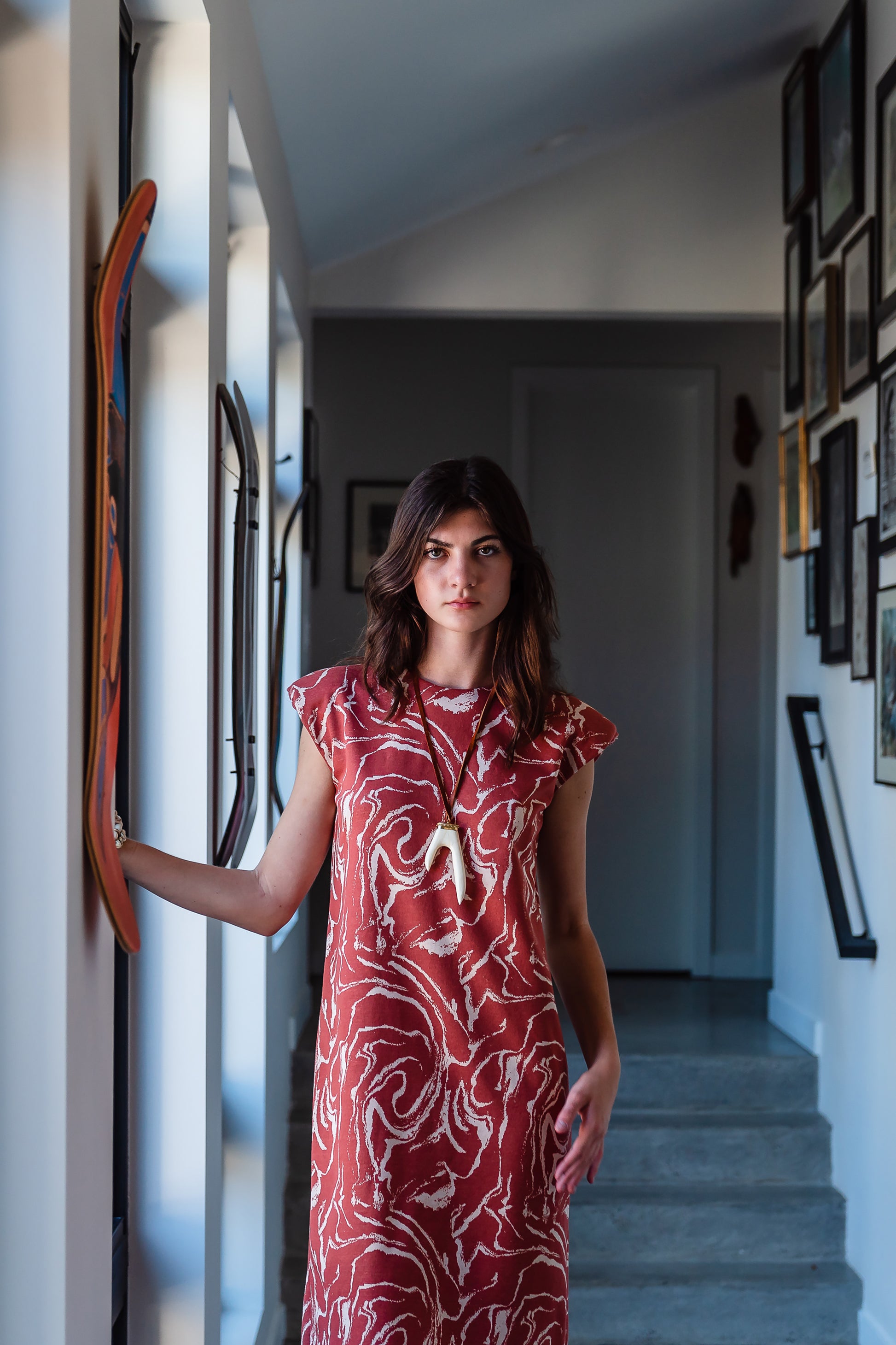 Knee length sleeveless shift dress, in a rust and taupe abstract, marble like pattern, the dress has shoulder pads.
