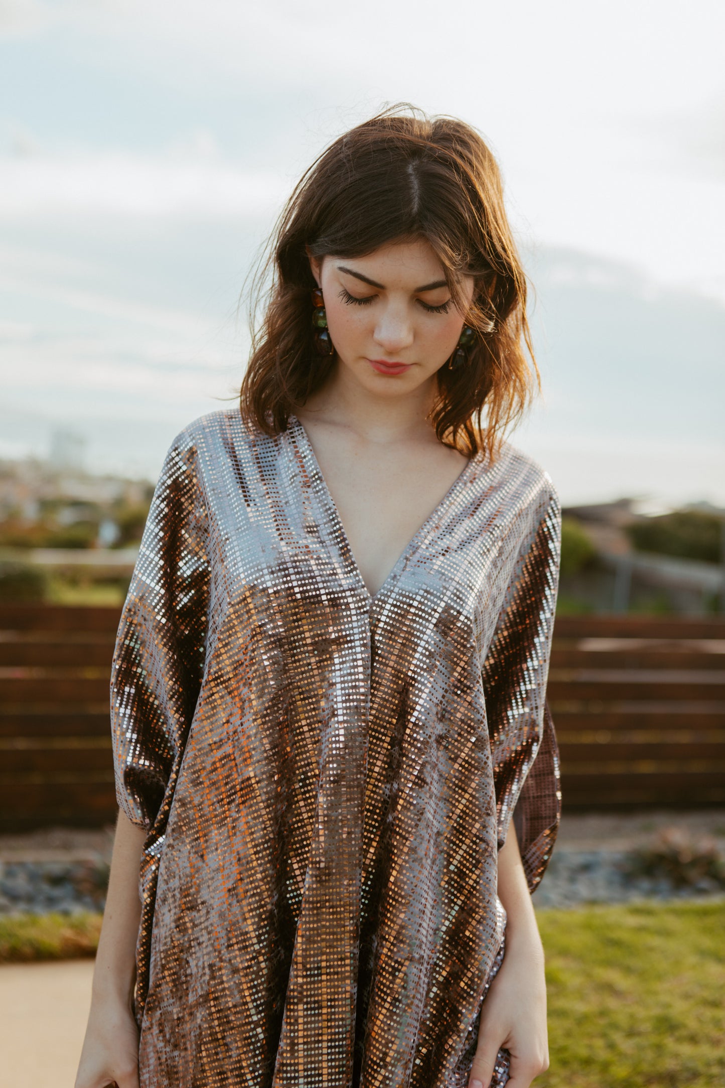 Full length velveteen caftan dress with a geometric metallic rose gold embellishments. Featuring a v-neck, batwing sleeves, and a full length hem. Retro futuristic bohemian style.