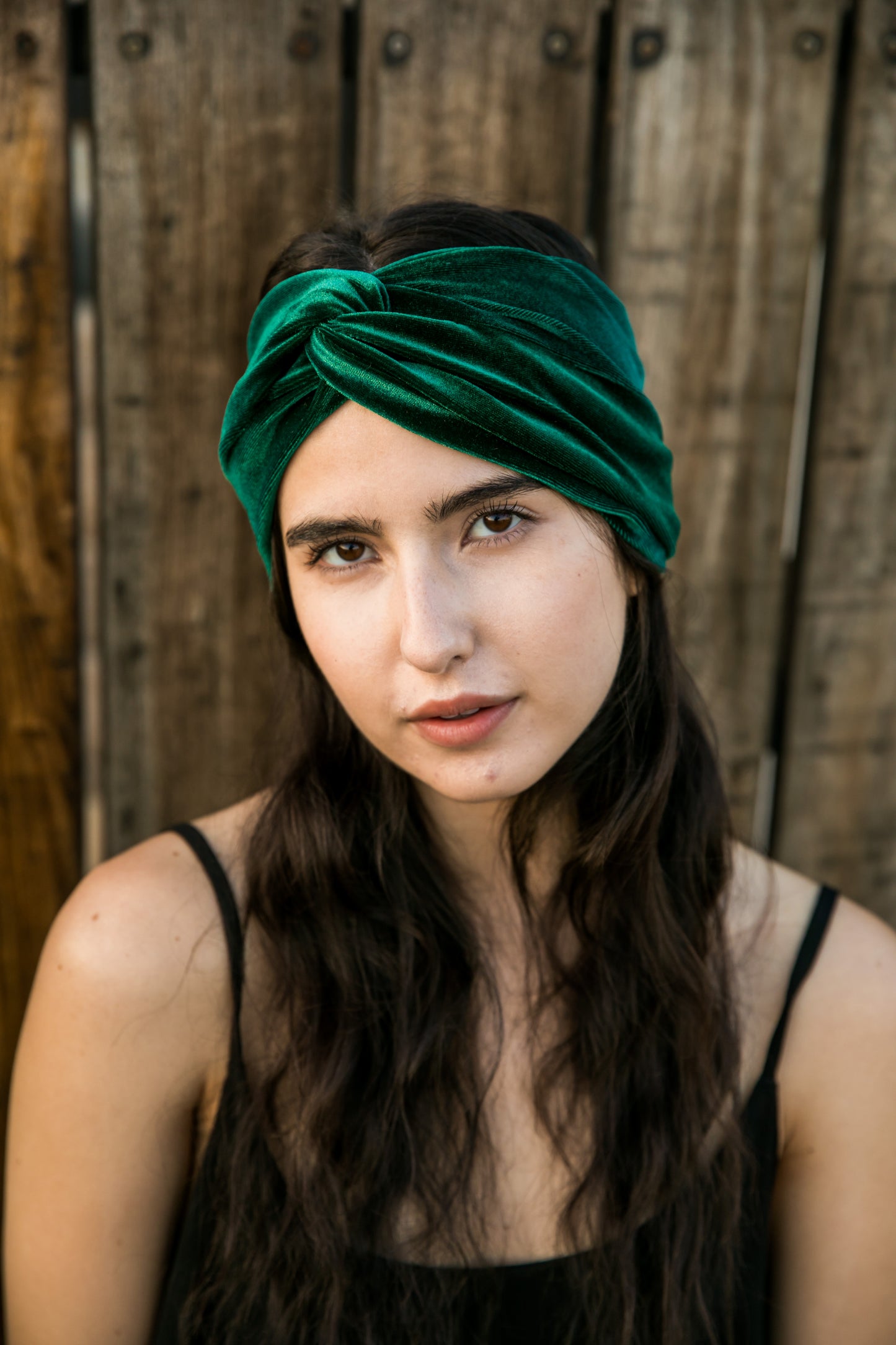 Wide, emerald green stretch velvet turban-esque fashion headband, with an elegant twist front and center. Vintage-inspired retro 1920s mixed with a modern fabric.