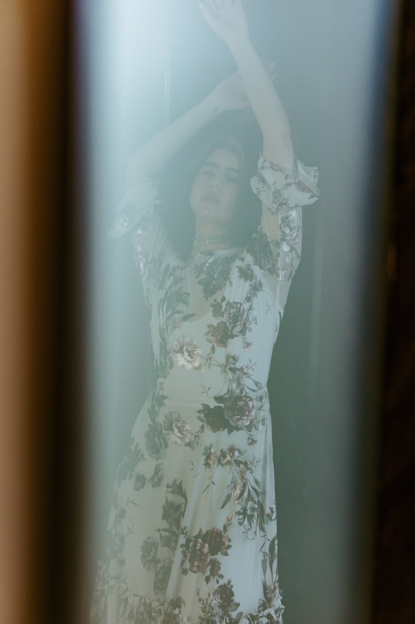 An airy ruffled maxi dress. Made with an airy and metallic detail floral mesh fabric featuring pockets, mid-length bell sleeves, and a full, single-tiered skirt with ankle hem. Includes a matching slip dress that can be worn on its own.