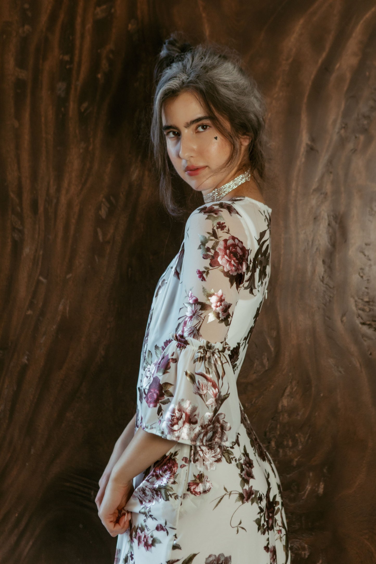 An airy ruffled maxi dress. Made with an airy and metallic detail floral mesh fabric featuring pockets, mid-length bell sleeves, and a full, single-tiered skirt with ankle hem. Includes a matching slip dress that can be worn on its own.