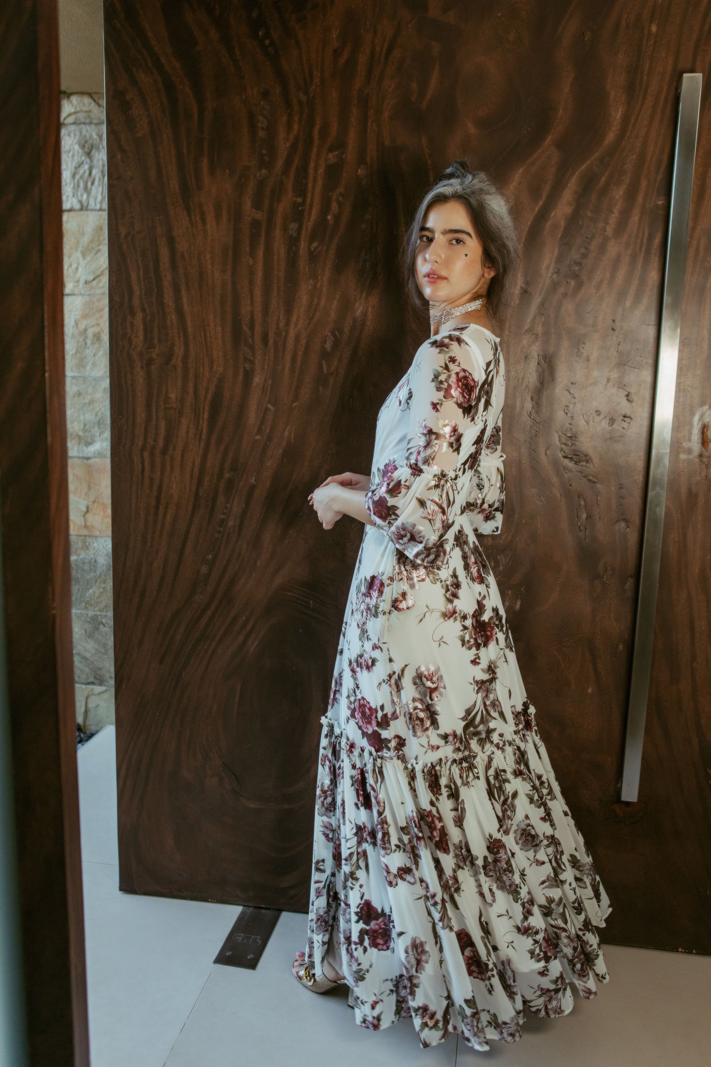 An airy ruffled maxi dress. Made with an airy and metallic detail floral mesh fabric featuring pockets, mid-length bell sleeves, and a full, single-tiered skirt with ankle hem. Includes a matching slip dress that can be worn on its own.