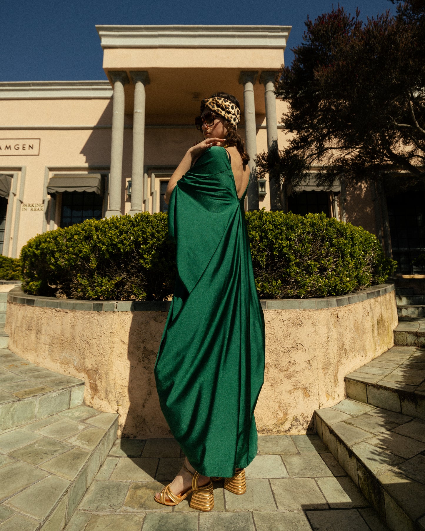 Elegant emerald green caftan made from jersey. Features a v-neck, batwing sleeves, and ankle hem.