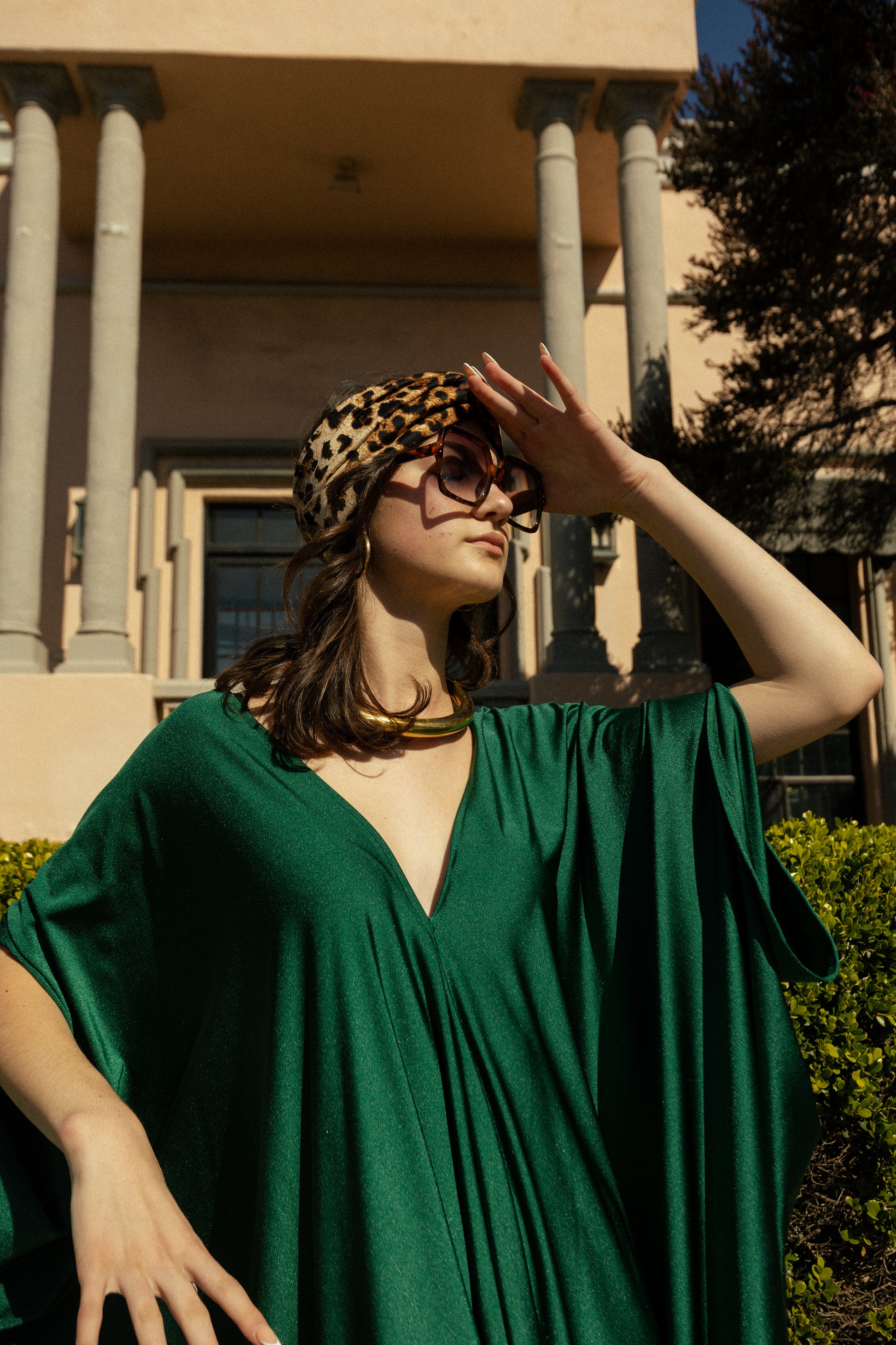 Elegant emerald green caftan made from jersey. Features a v-neck, batwing sleeves, and ankle hem.