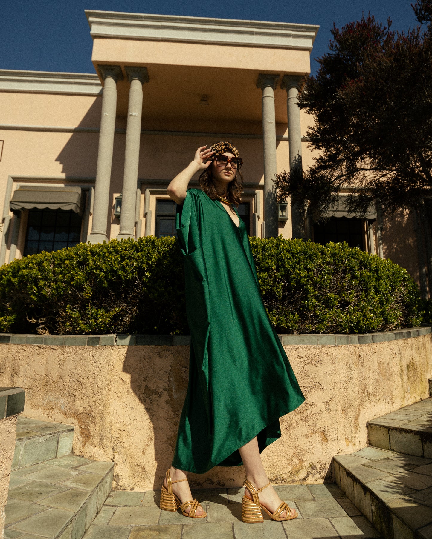 Elegant emerald green caftan made from jersey. Features a v-neck, batwing sleeves, and ankle hem.