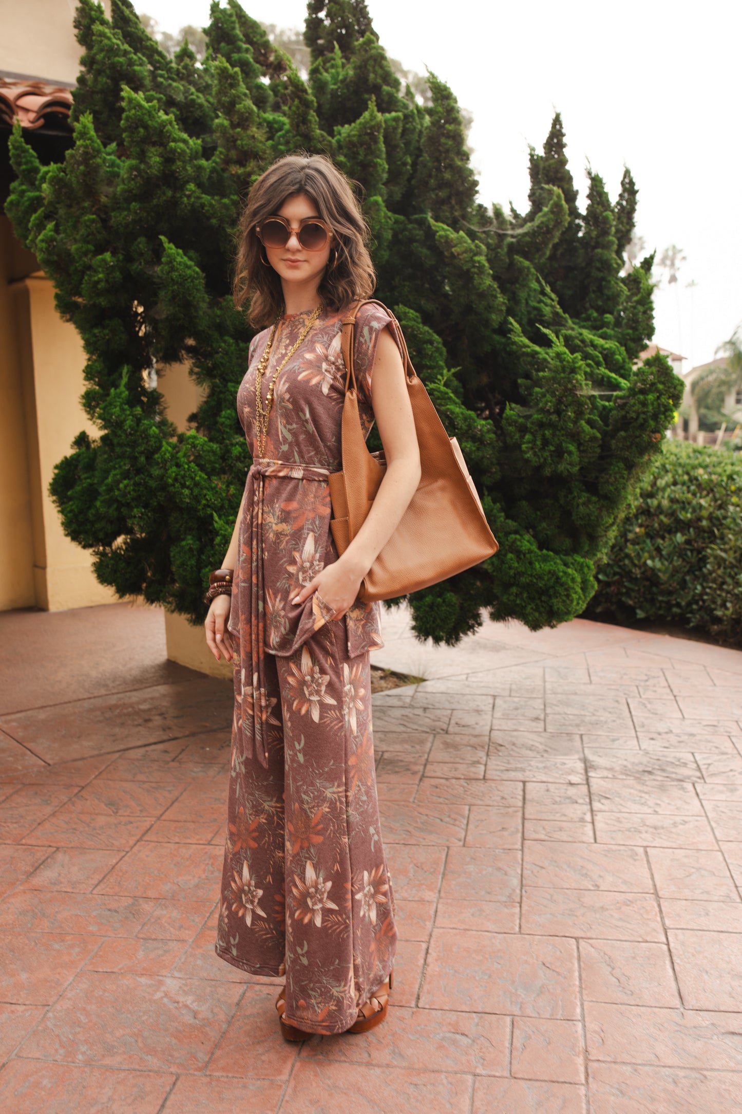 Tunic top and palazzo pant set made from a luxe jersey. Muted red base with orange floral print. Featuring tab sleeves, side slits and an extended obi-style belt on the top, and pockets, elastic waist and a soft hidden drawstring on the bottoms.