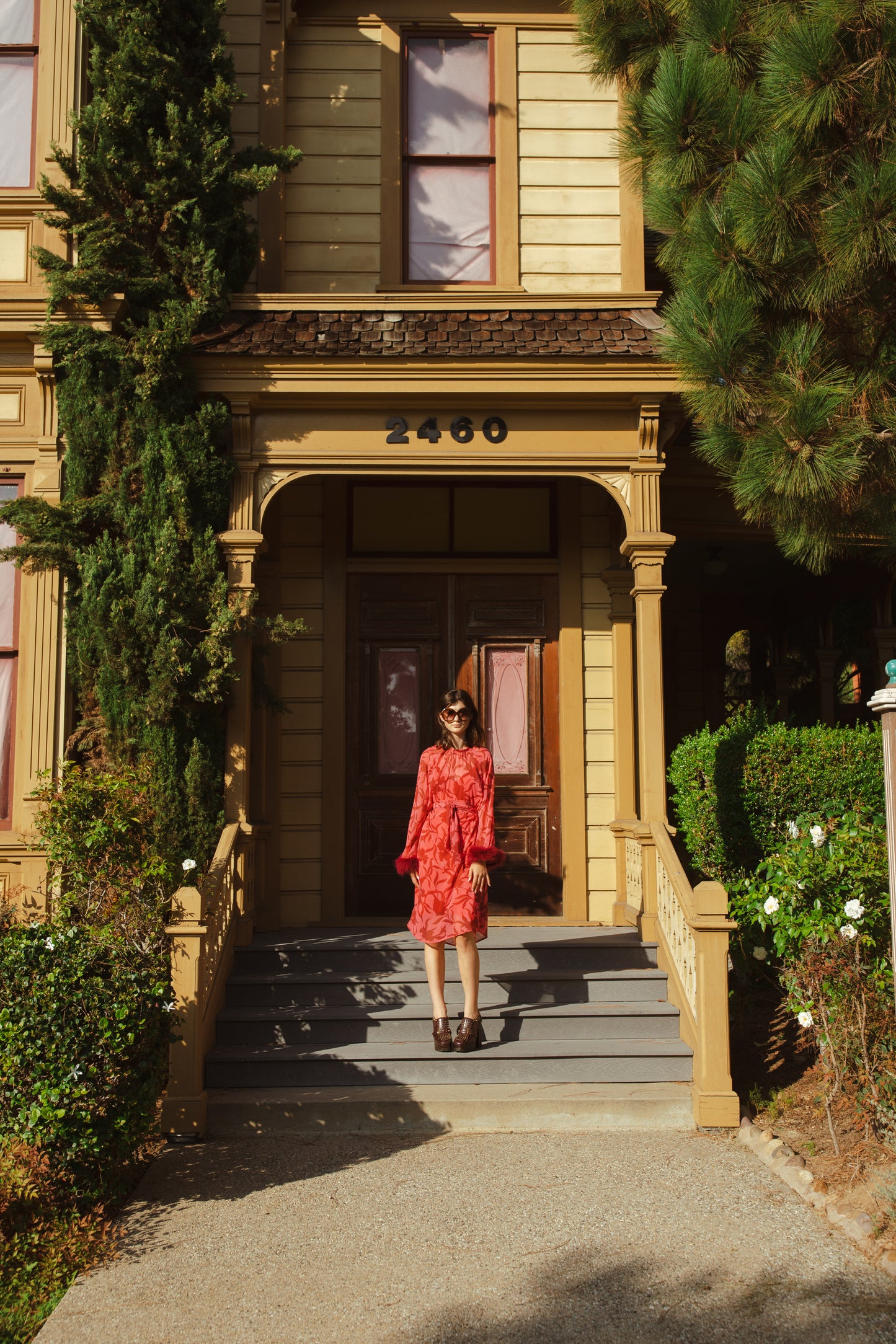 This sophisticated stunner has all the right details - generous bell sleeves with feather detail, flowing knee-length midi skirt, and a slim matching sash for a cinched waist.