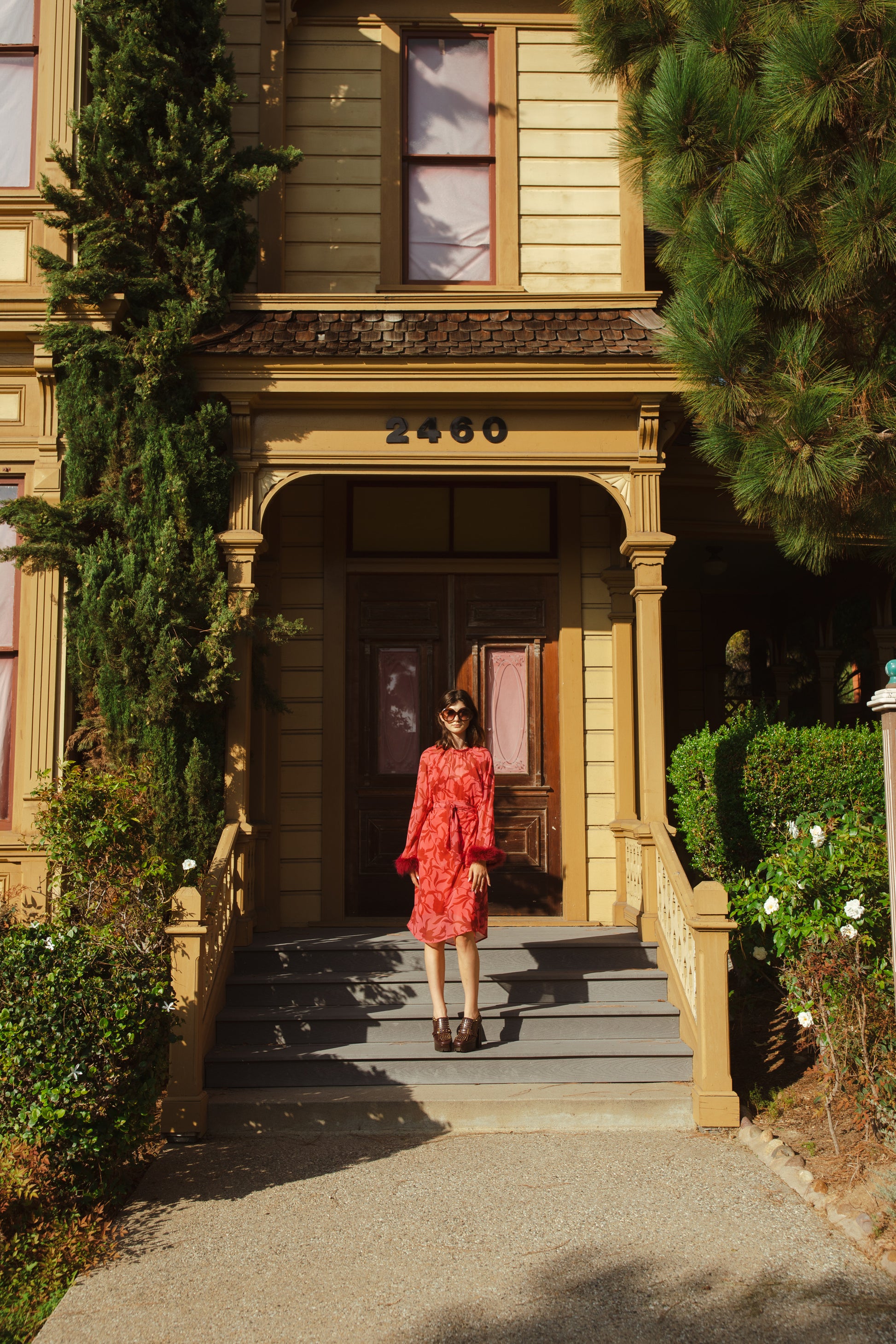 This sophisticated stunner has all the right details - generous bell sleeves with feather detail, flowing knee-length midi skirt, and a slim matching sash for a cinched waist.