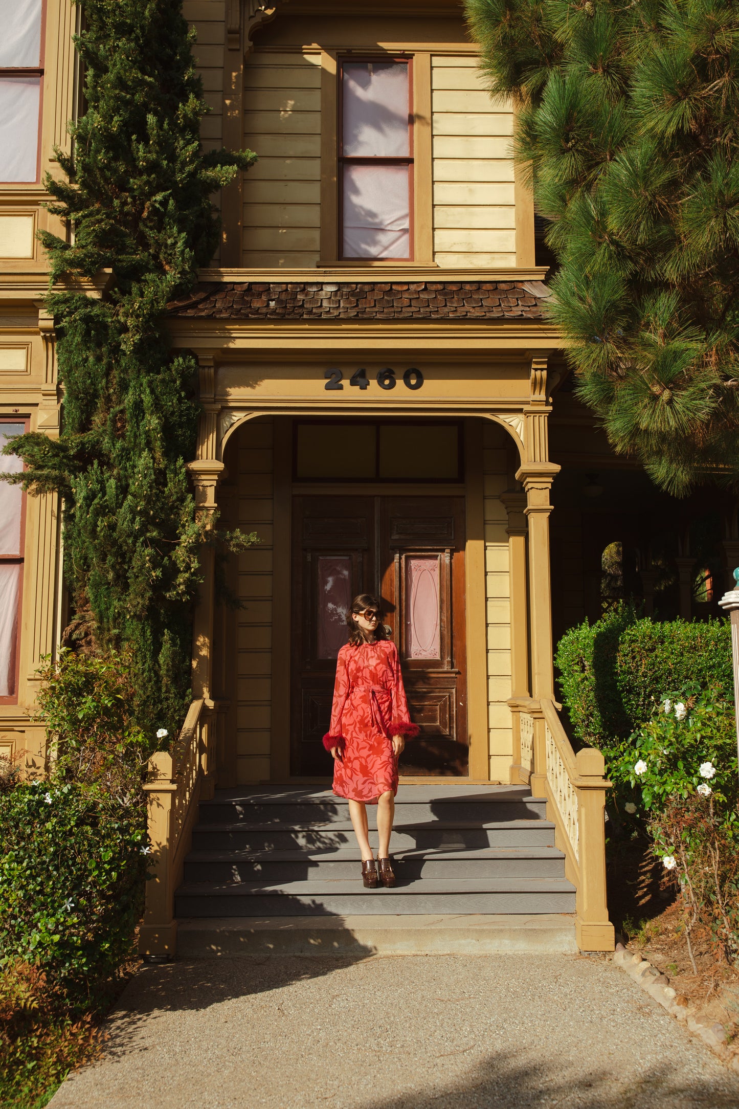 This sophisticated stunner has all the right details - generous bell sleeves with feather detail, flowing knee-length midi skirt, and a slim matching sash for a cinched waist.