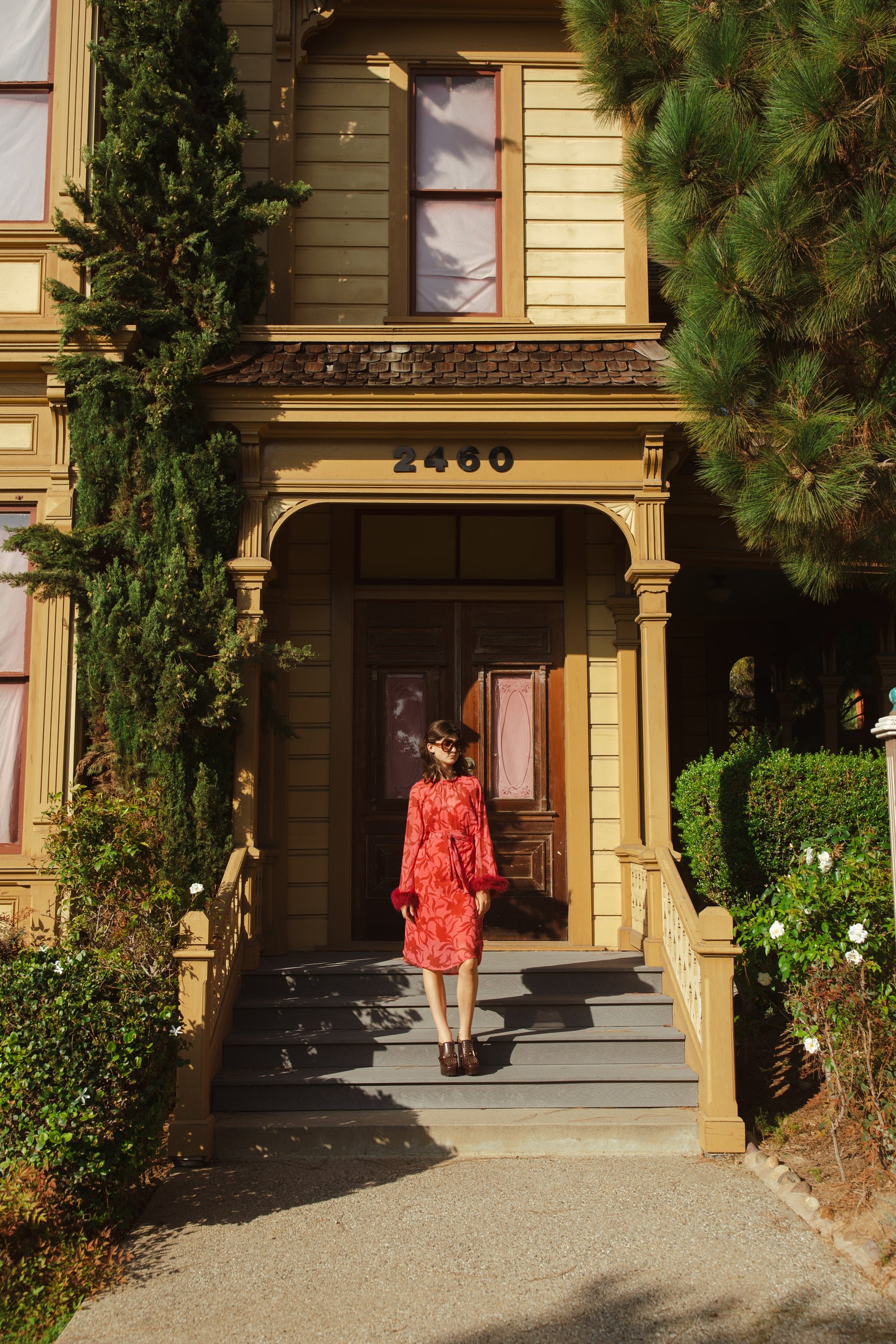 This sophisticated stunner has all the right details - generous bell sleeves with feather detail, flowing knee-length midi skirt, and a slim matching sash for a cinched waist.