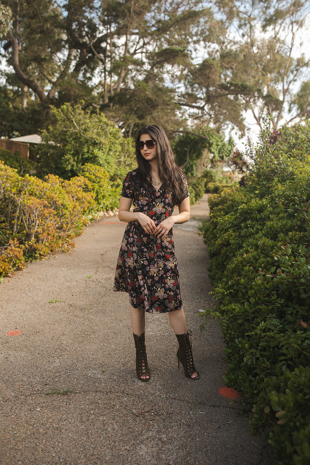 Short-sleeve, v-neck wrap dress. Midi in length, with black base with multicolor vintage-inspired botanical floral flower print. Bohemian summer dress in style.