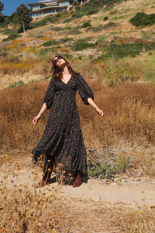 Turn heads in this beautiful yet understated floral maxi. Crafted with a softly luscious linenlike cotton/rayon, it features v-neck, detailed bishop sleeves, tiered ruffle skirt and a keyhole slit at back for a little extra sass.