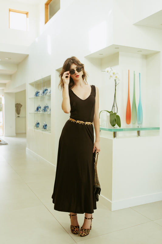A-Line Slip Dress is made of cotton jersey fabric. Featuring a deep v-neckline, sleeveless, with ankle hem in solid black.