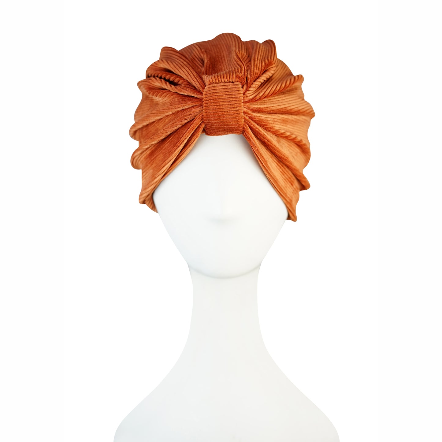 Apricot orange, ribbed stretch velvet fashion turban hat that wears similar to a beanie, with ruching of the fabric that meets front and center at an elegant knot. Vintage-inspired retro 1920s mixed with a modern fabric.