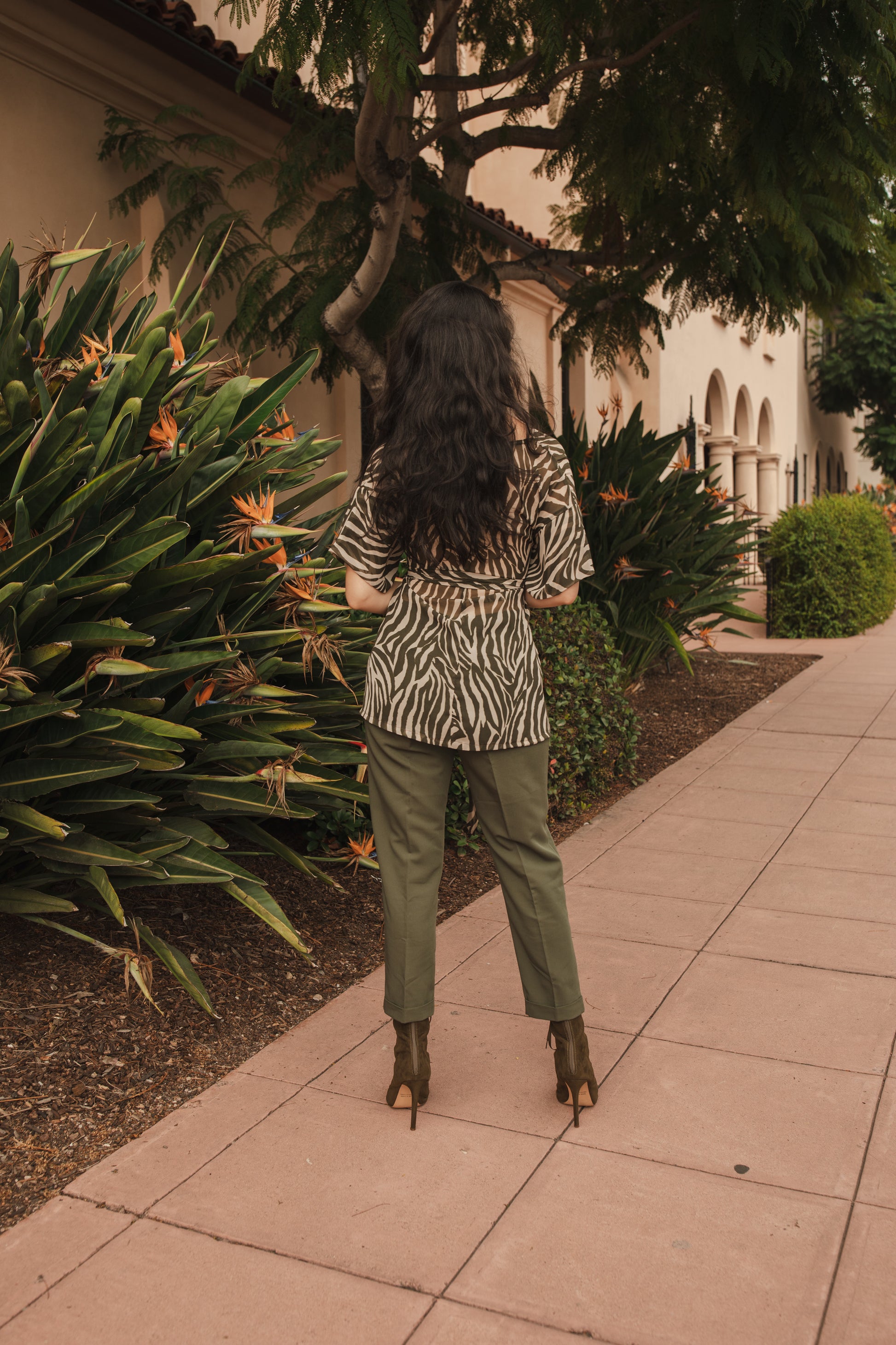 Tunic top with large flowy short sleeves and wide short v-neck. Featuring an olive green zebra print in semi-sheer chiffon with matching waist tie.