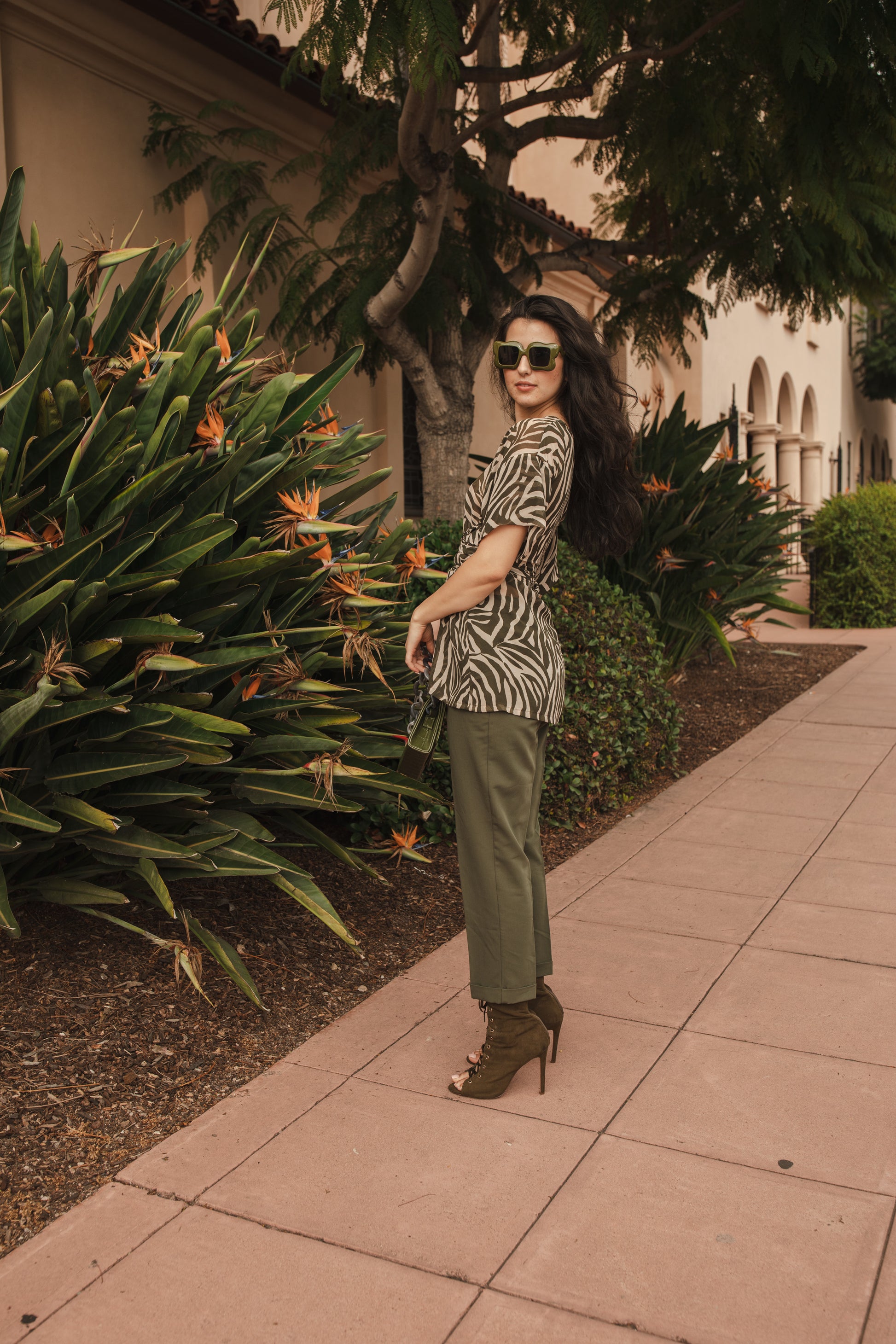 Tunic top with large flowy short sleeves and wide short v-neck. Featuring an olive green zebra print in semi-sheer chiffon with matching waist tie.