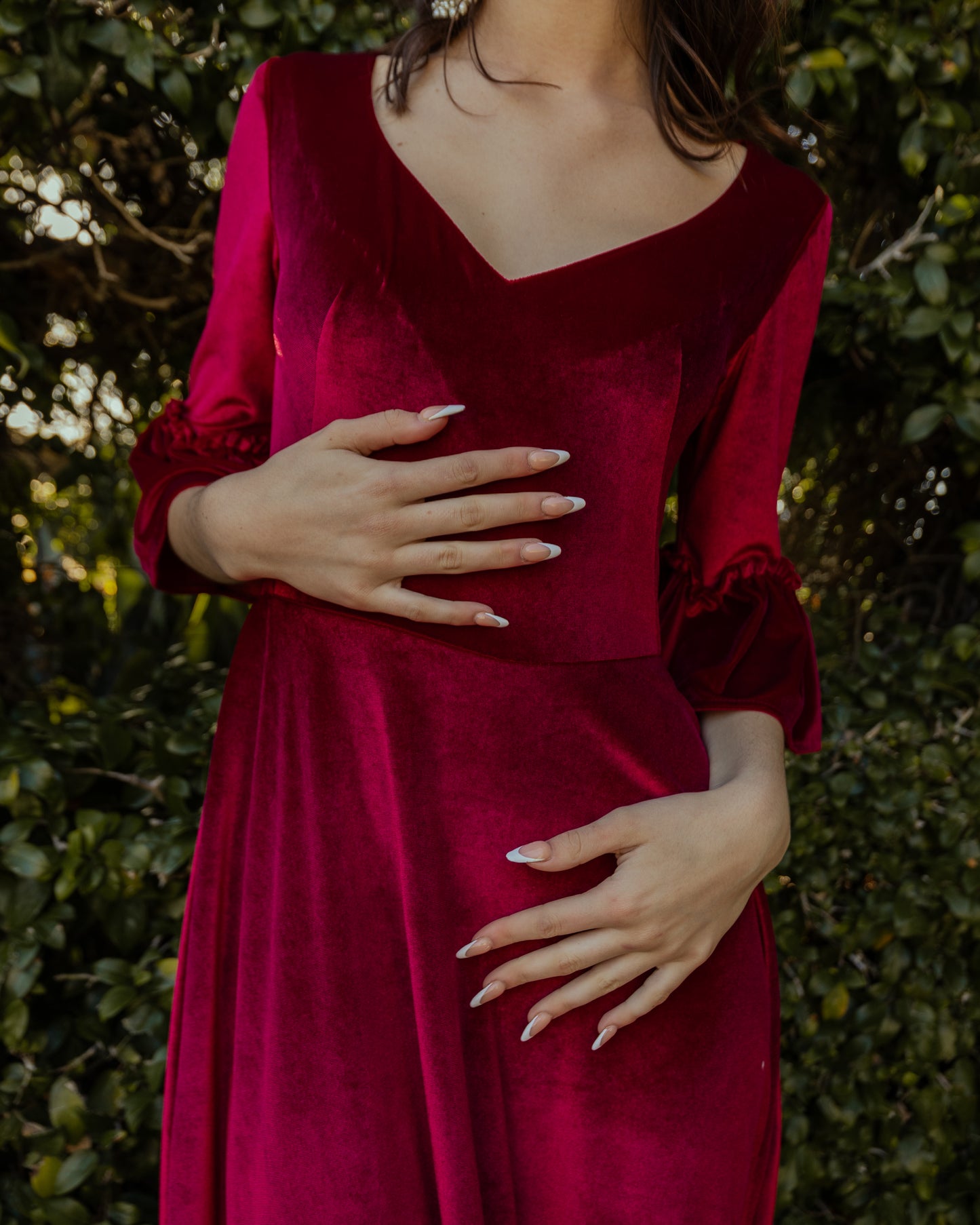 This deep red velvet sweetheart dress features bell sleeves and a full tiered ruffle skirt. With an optional sweetheart cut out in back, you can show off a little skin while still concealing your bra.