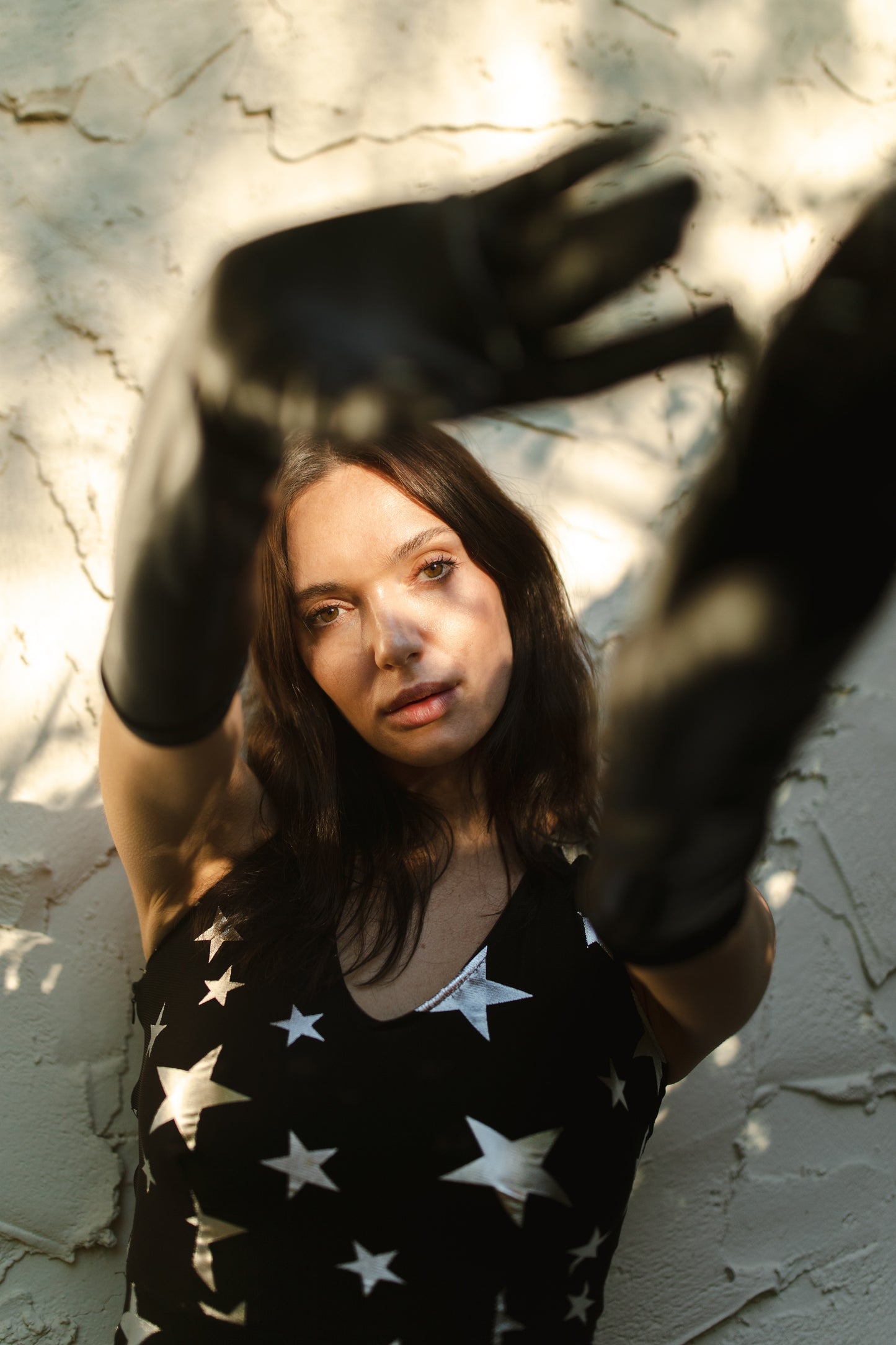 A magical form-fitting mermaid maxi dress features a cutout at mid-back. With a V-neckline and ankle hem, it is crafted from a soft black mesh with metallic silver foil star print and bamboo blend jersey lining.