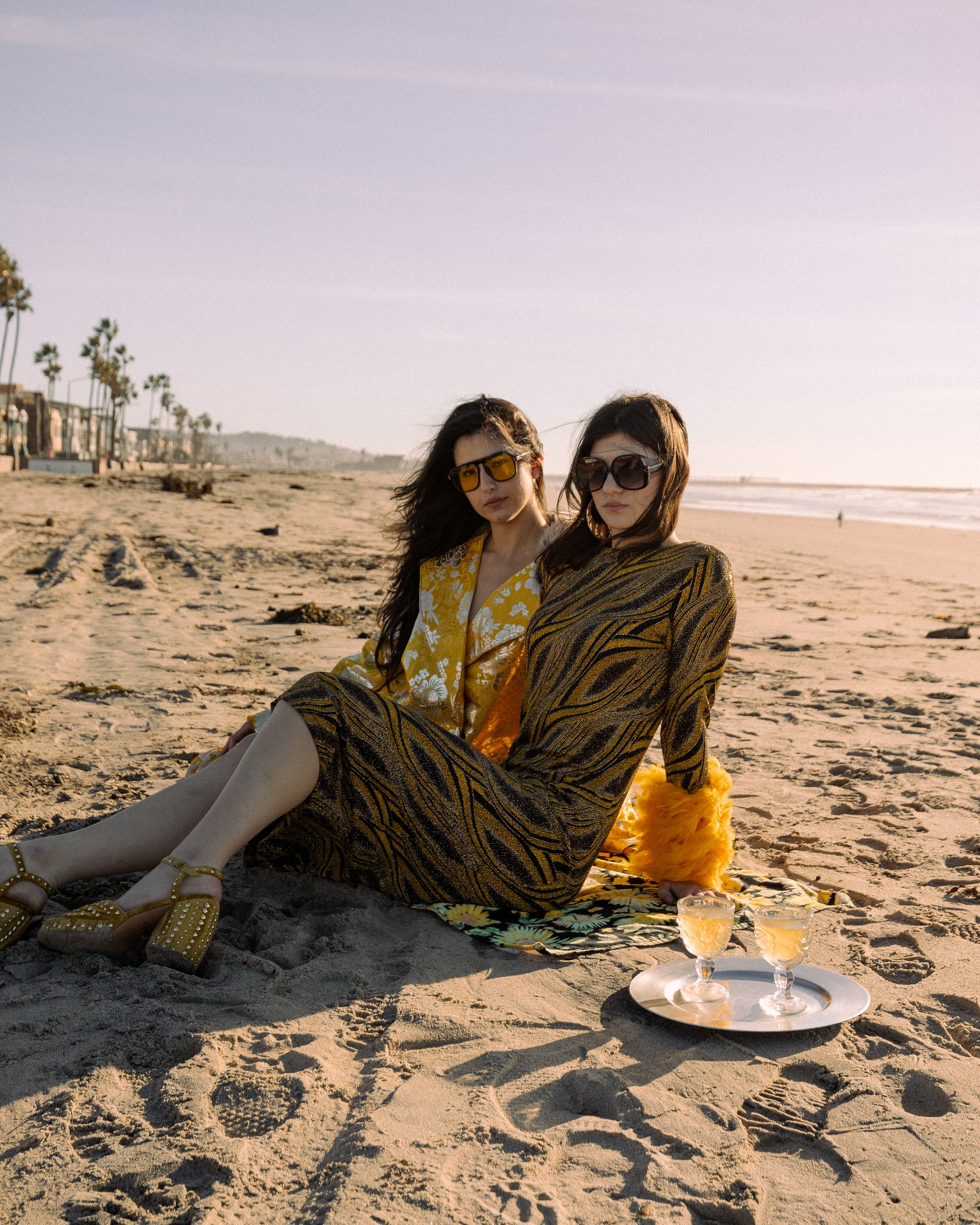 This pop-art bodycon dress accentuates your curves, while the removable feather trim on the sleeves adds a touch of elegance. The yellow cuffs and black and yellow fabric are perfect for those who shine bright.
