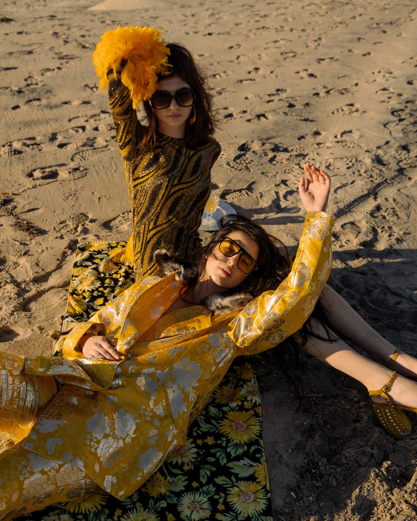 This pop-art bodycon dress accentuates your curves, while the removable feather trim on the sleeves adds a touch of elegance. The yellow cuffs and black and yellow fabric are perfect for those who shine bright.