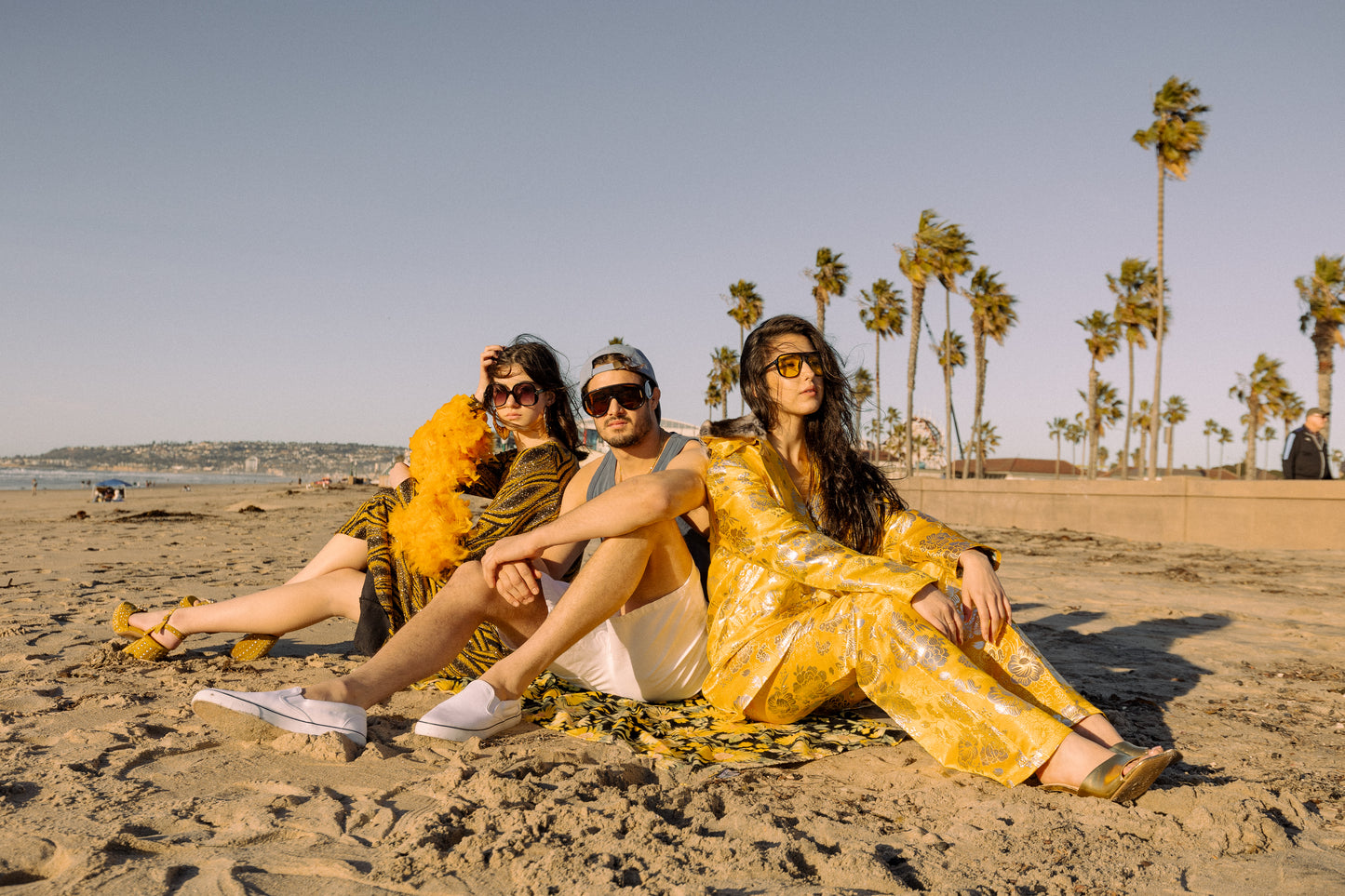 This pop-art bodycon dress accentuates your curves, while the removable feather trim on the sleeves adds a touch of elegance. The yellow cuffs and black and yellow fabric are perfect for those who shine bright.