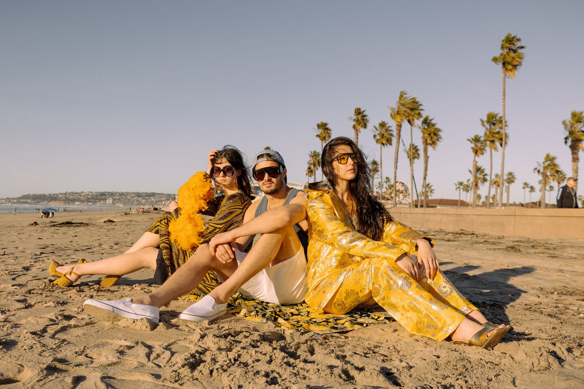 This pop-art bodycon dress accentuates your curves, while the removable feather trim on the sleeves adds a touch of elegance. The yellow cuffs and black and yellow fabric are perfect for those who shine bright.