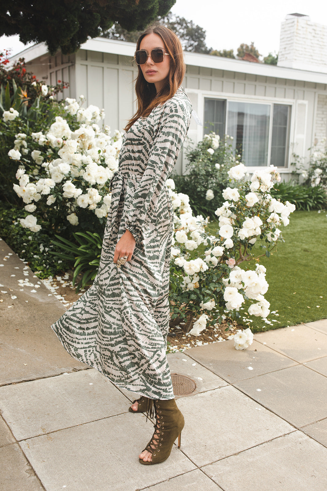 This sophisticated dress has all the right details -generous bishop sleeves, flowing maxi skirt, and a slim matching sash for a cinched waist. Crafted with a sleek, airy fabric that drapes beautifully to create a timeless silhouette