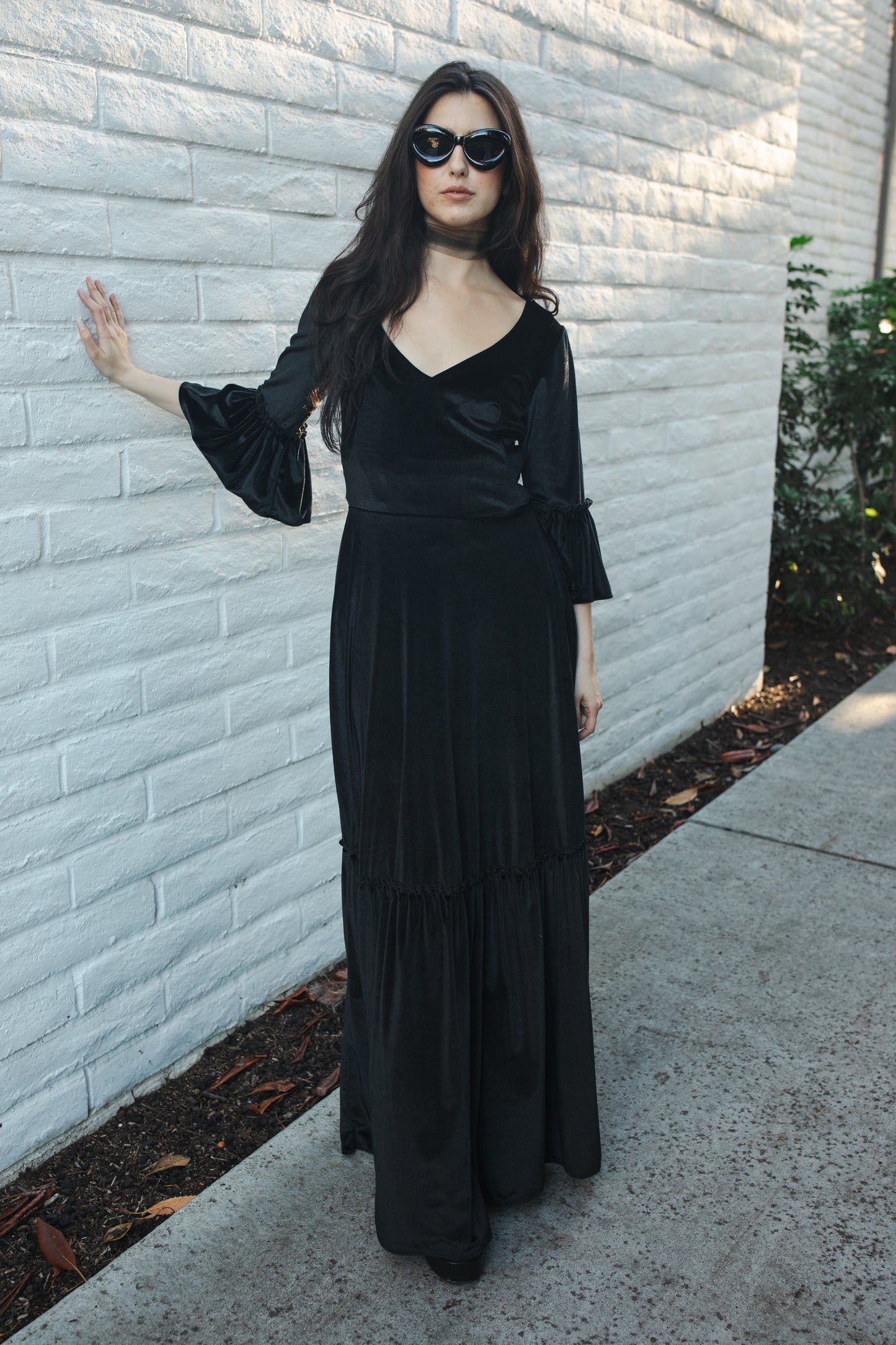 This black velvet sweetheart dress features bell sleeves and a full tiered ruffle skirt. With an optional sweetheart cut out in back, you can show off a little skin while still concealing your bra.  Ankle hem and v-neckline. 