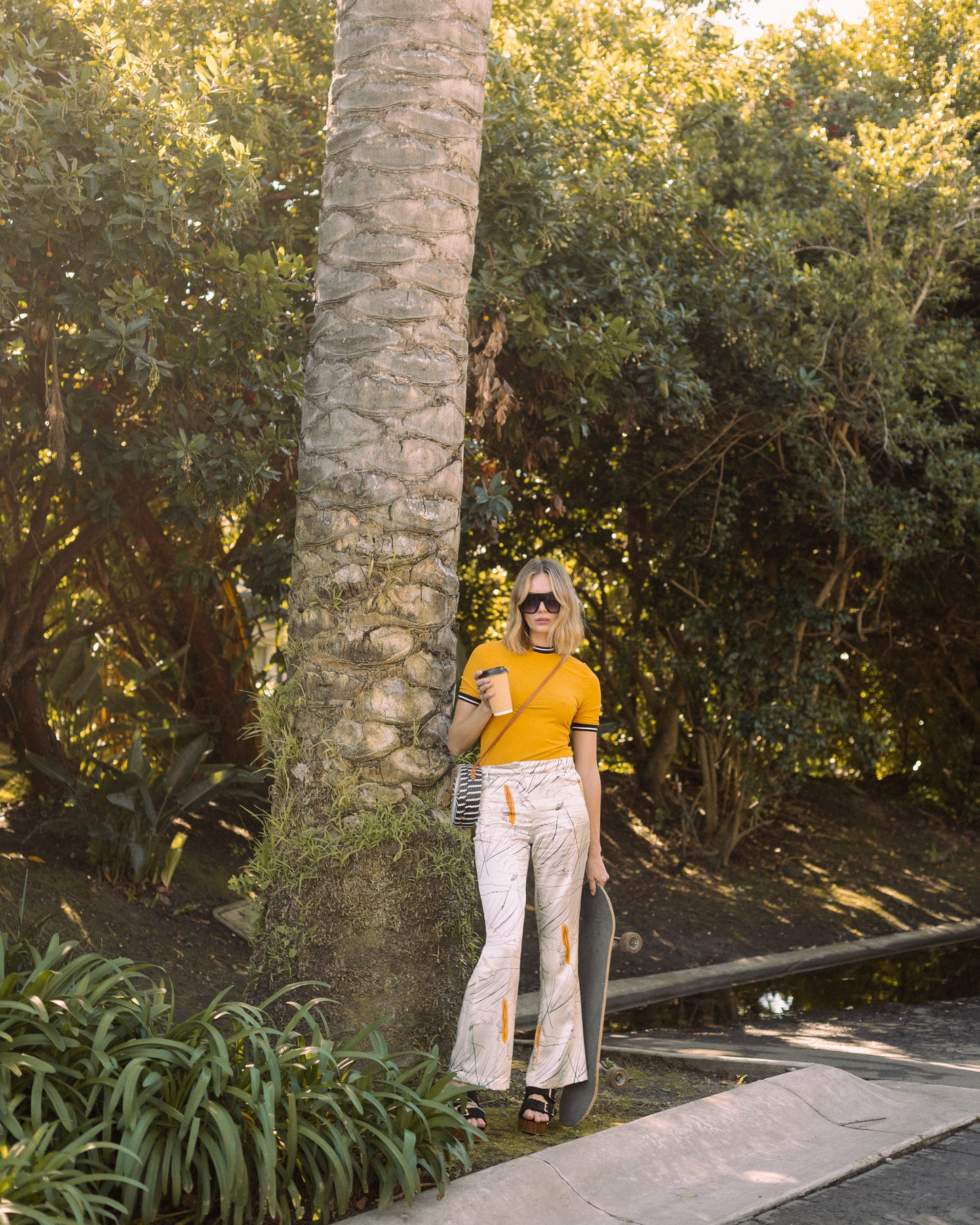 Channel your inner risk-taker in our Venusian Silk Trousers. Made of luxurious silk satin, these cream-colored trousers feature a bold out of this world Surfer/UFO print that will make you stand out