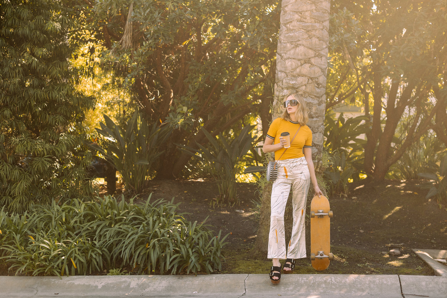 Channel your inner risk-taker in our Venusian Silk Trousers. Made of luxurious silk satin, these cream-colored trousers feature a bold out of this world Surfer/UFO print that will make you stand out