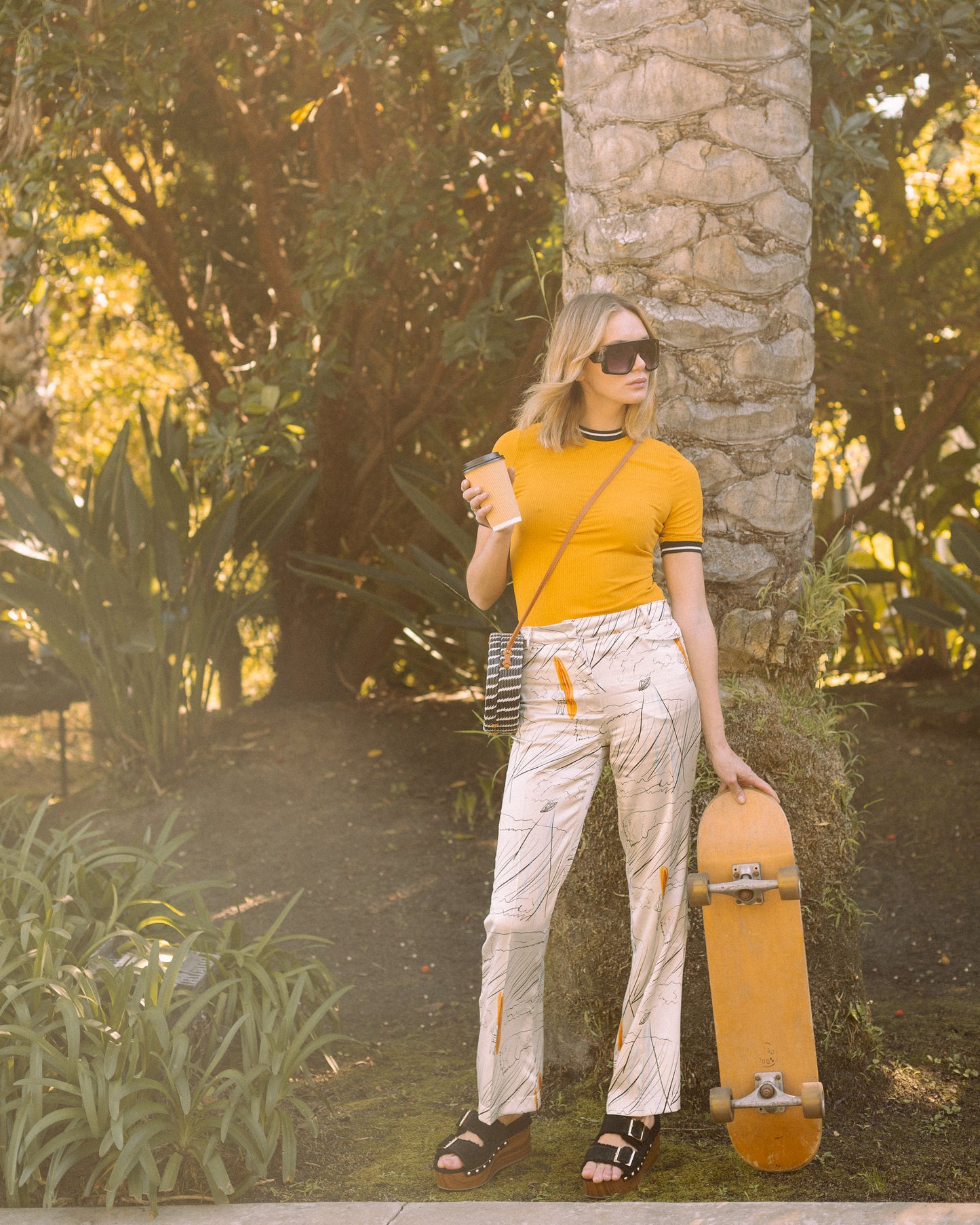 Channel your inner risk-taker in our Venusian Silk Trousers. Made of luxurious silk satin, these cream-colored trousers feature a bold out of this world Surfer/UFO print that will make you stand out