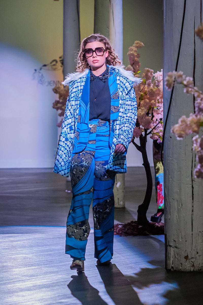 Boasting a striking aquarian color scheme on hand printed african fabric, this stylish piece is lined with a lush blue jersey and features a removable faux fur collar.